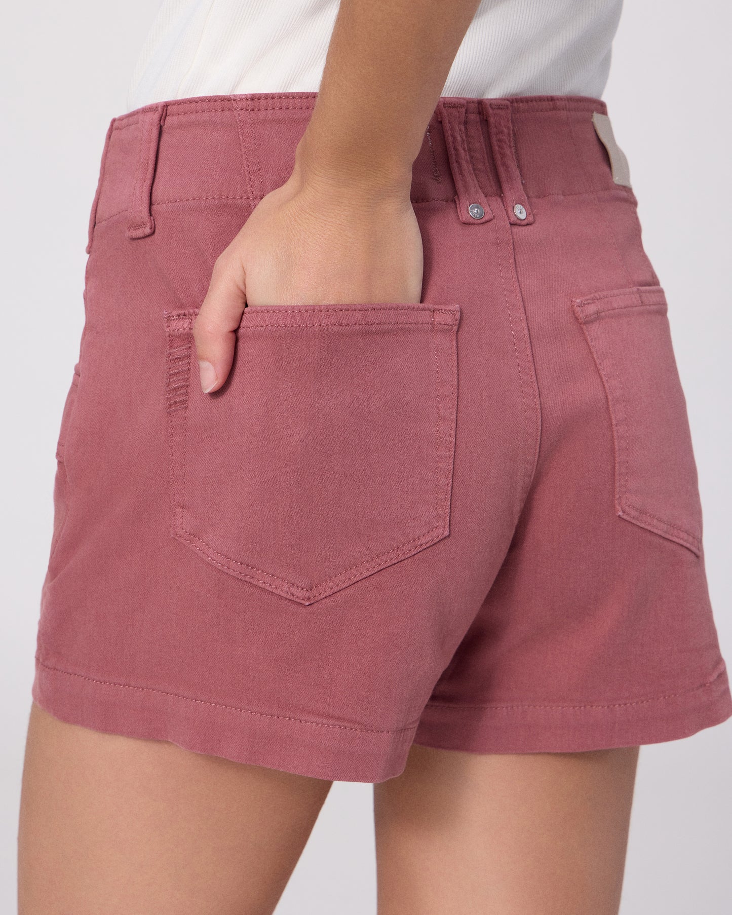 Women wearing a white tee and pink shorts on a white background
