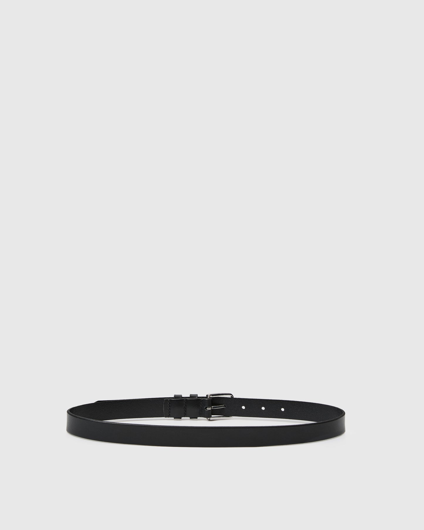 Black belt with a silver buckle on a light gray background