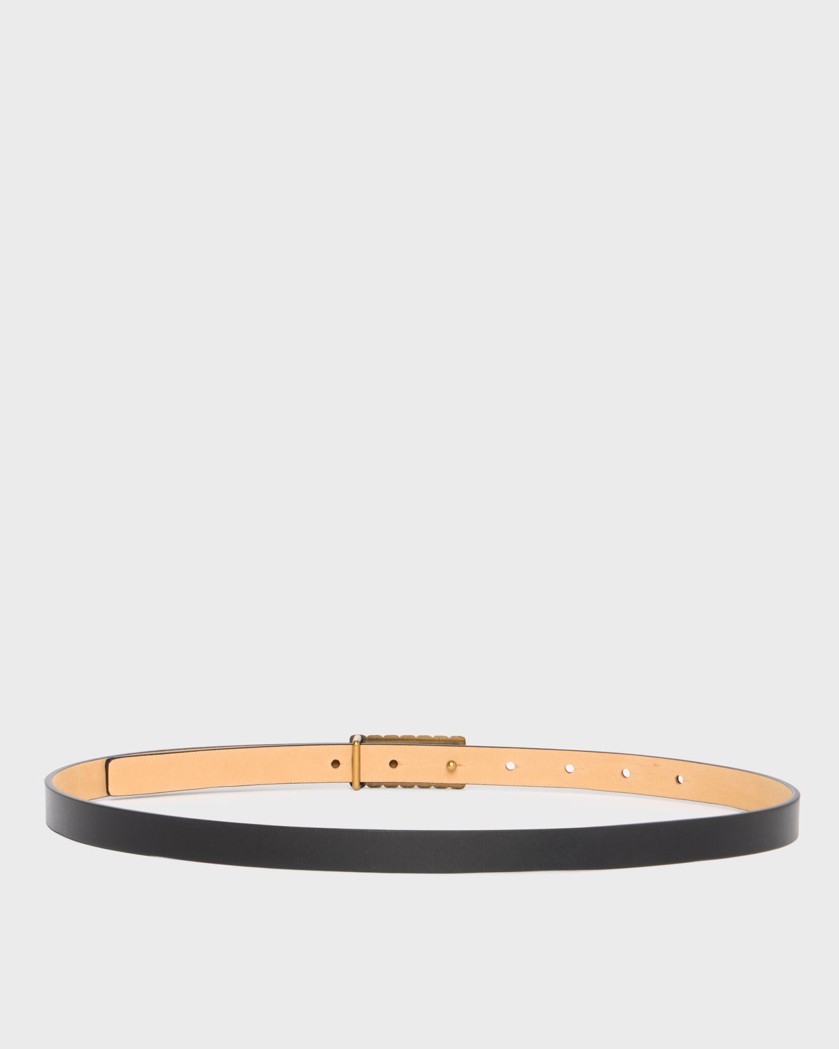 A minimalist black leather belt with a wide tan interior lining and a central gold-toned textured rectangular buckle, displayed horizontally on a light gray background.