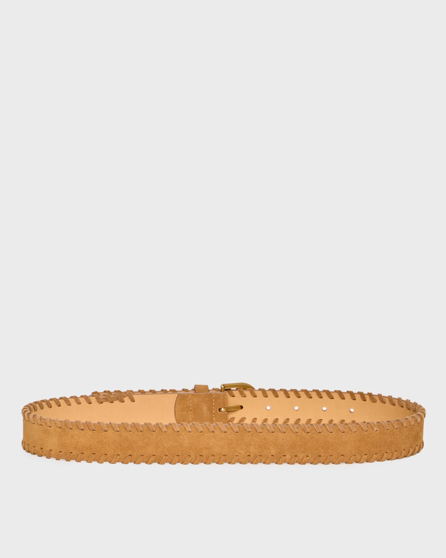 A light tan suede belt with decorative zigzag stitching along the edge and a matching buckle, displayed horizontally against a solid light gray background.