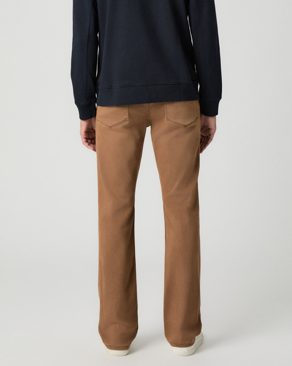 Back view from the waist down of the Normandie 32 Inch Straight Leg Jean in Vintage Sierra Canyon, worn with white sneakers