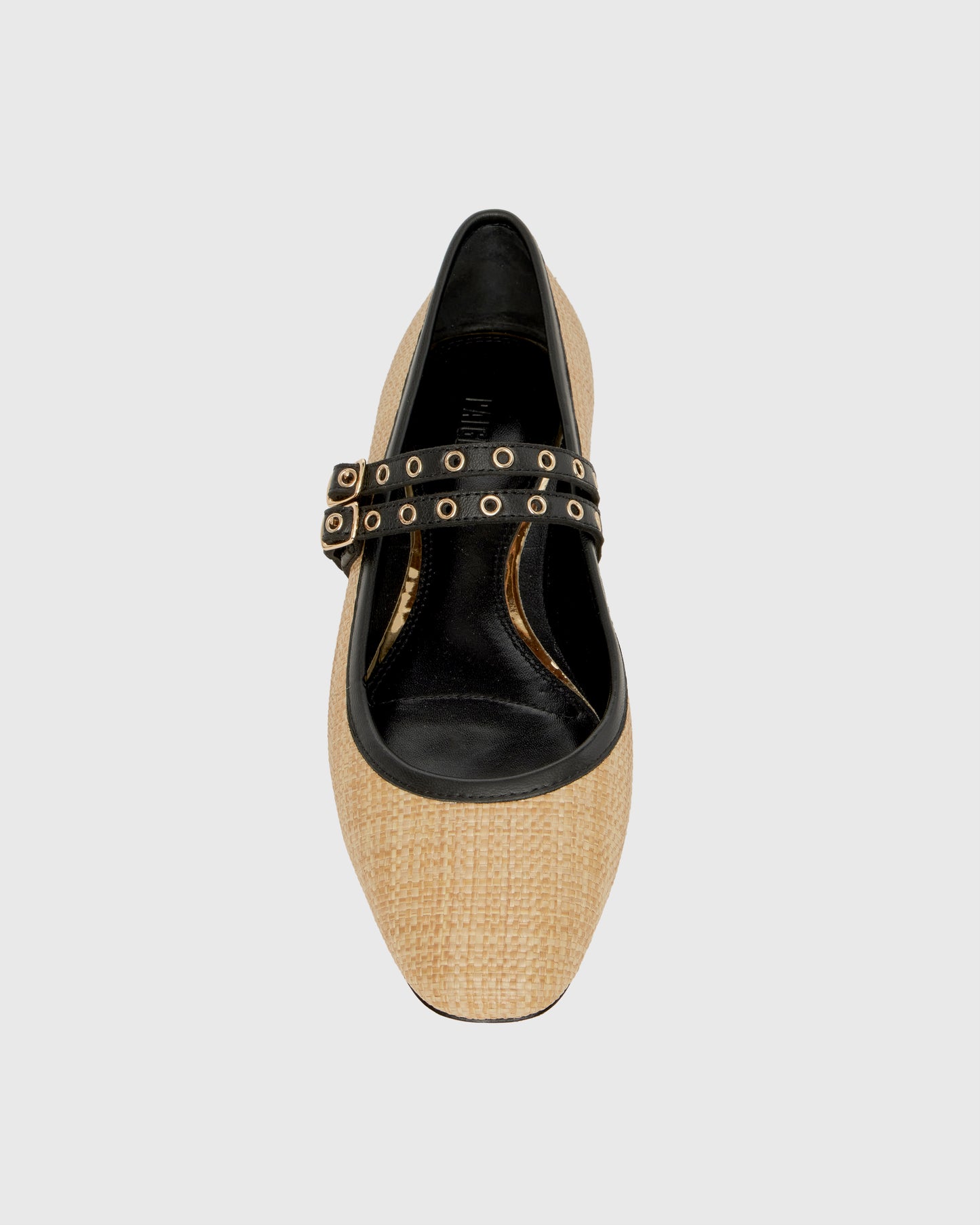 Two-tone shoe with straw-like material and black accents on a light gray background