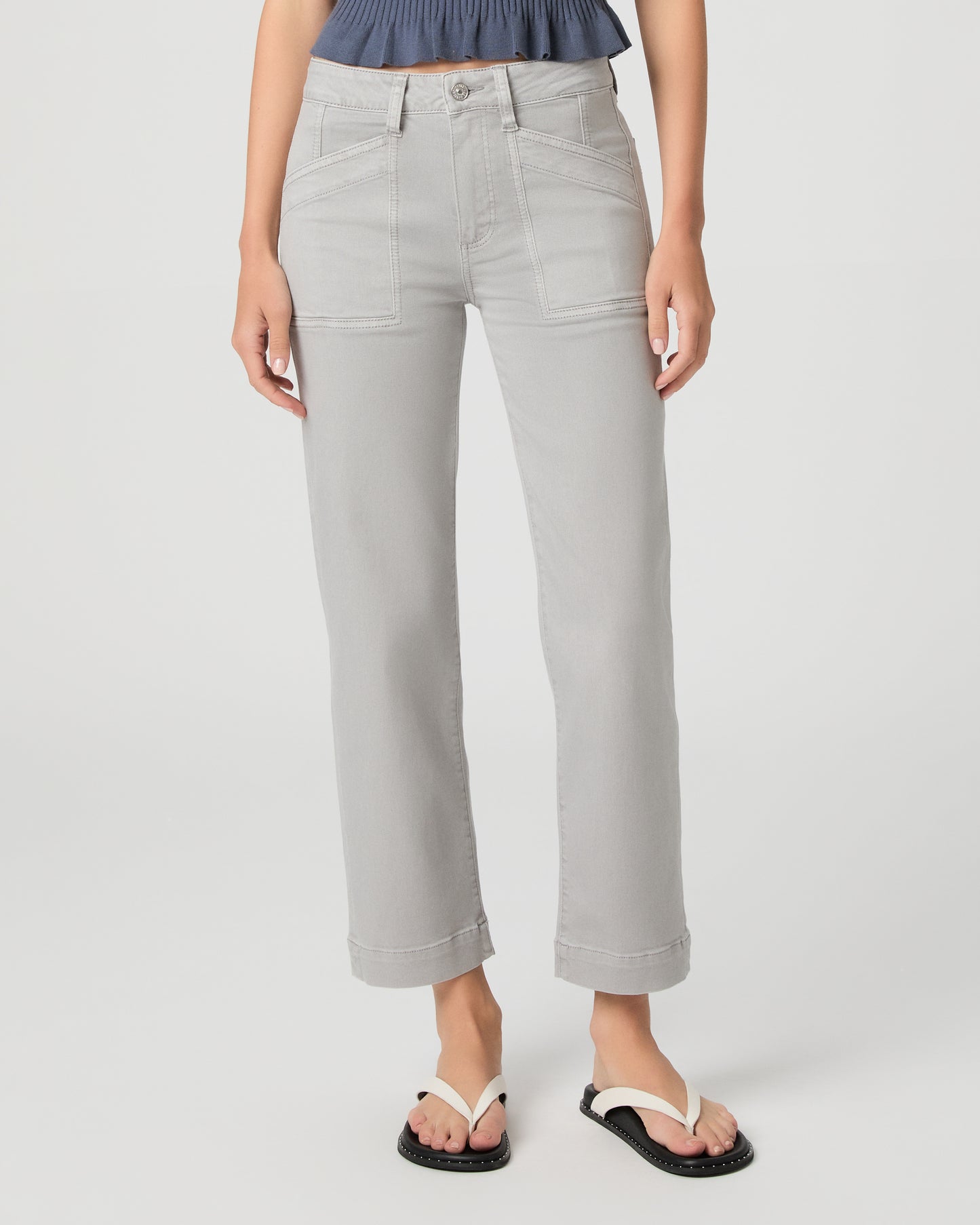 Person wearing light gray pants on a white background