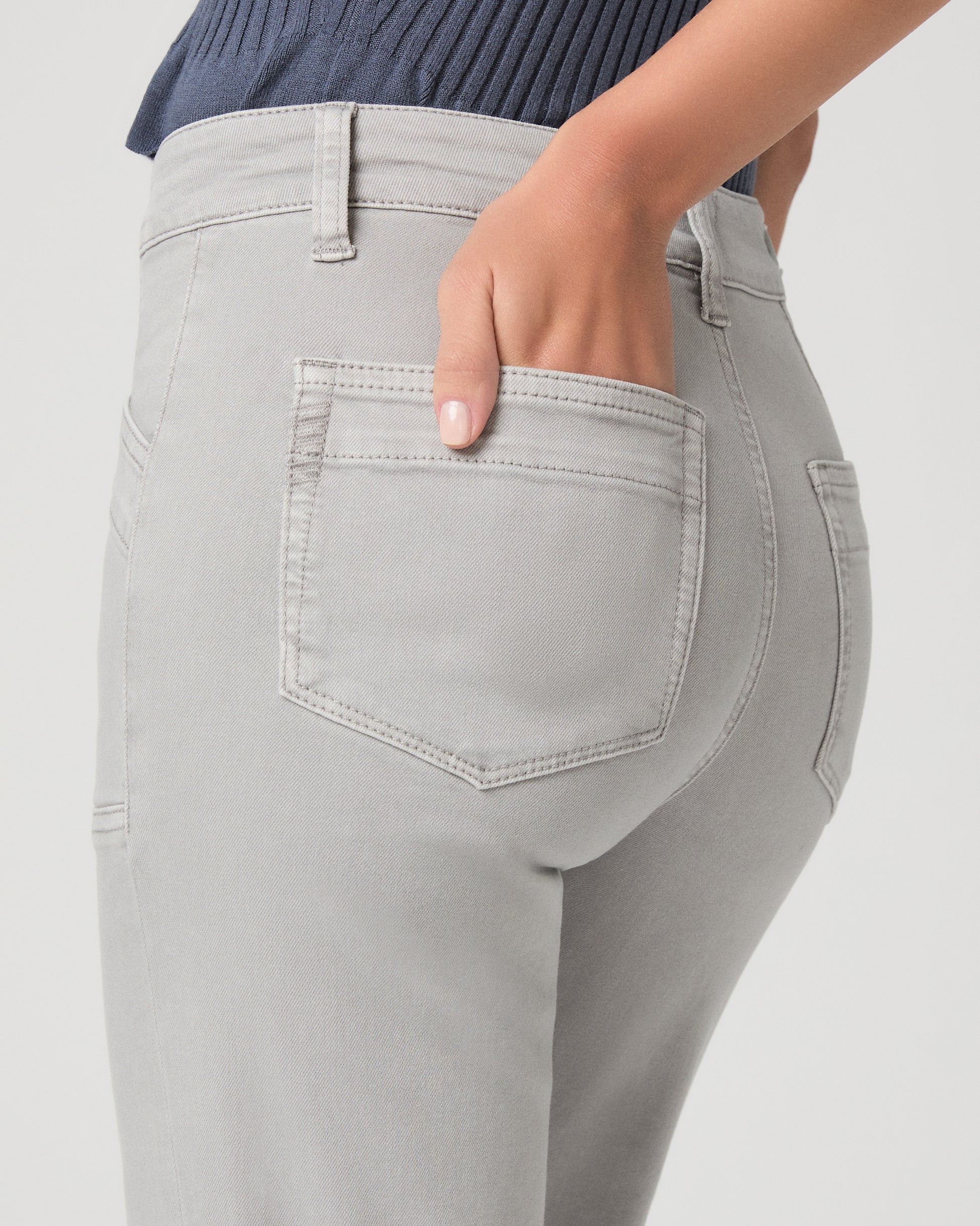 Gray pants with a pocket detail on a light gray background