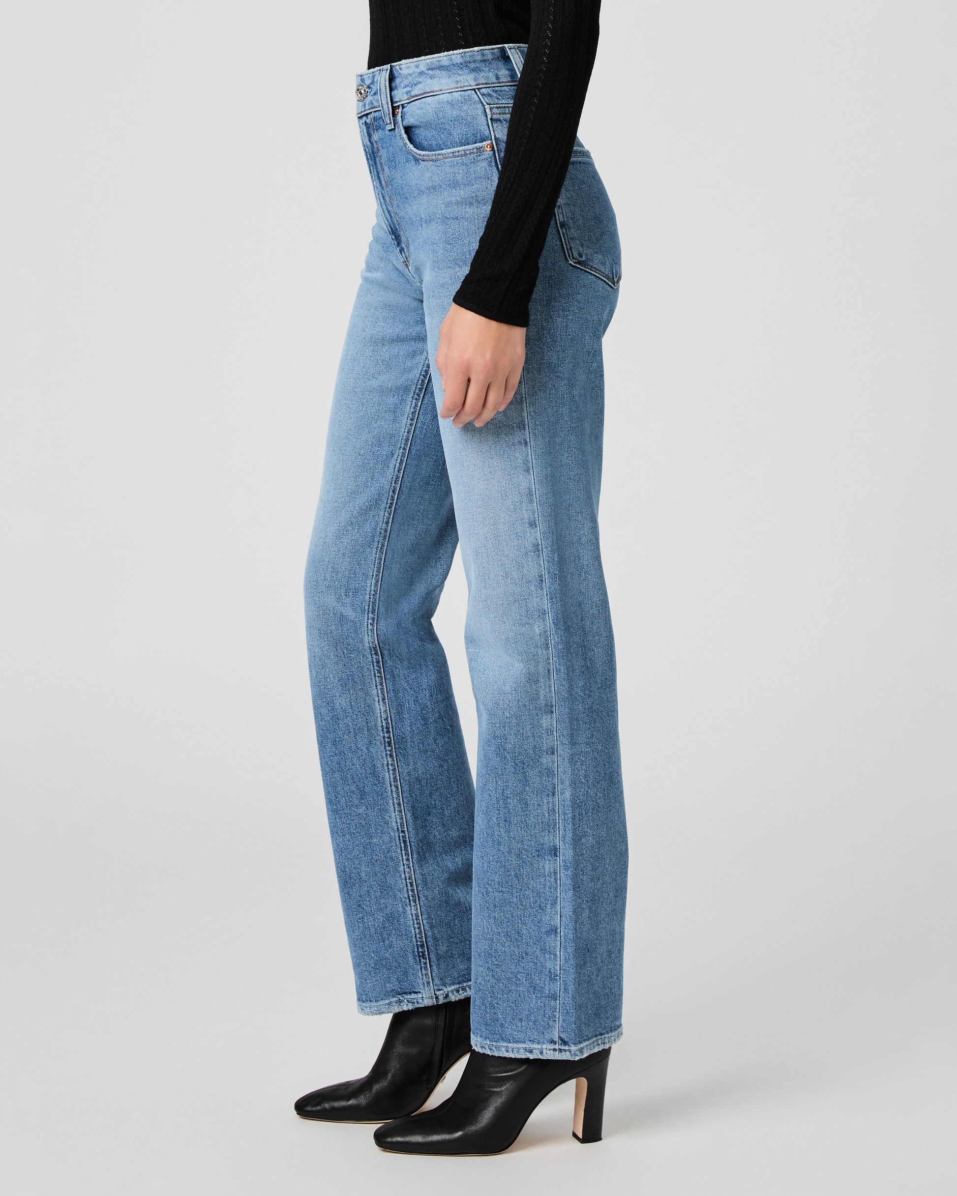 Light blue jeans worn by a person on a white background