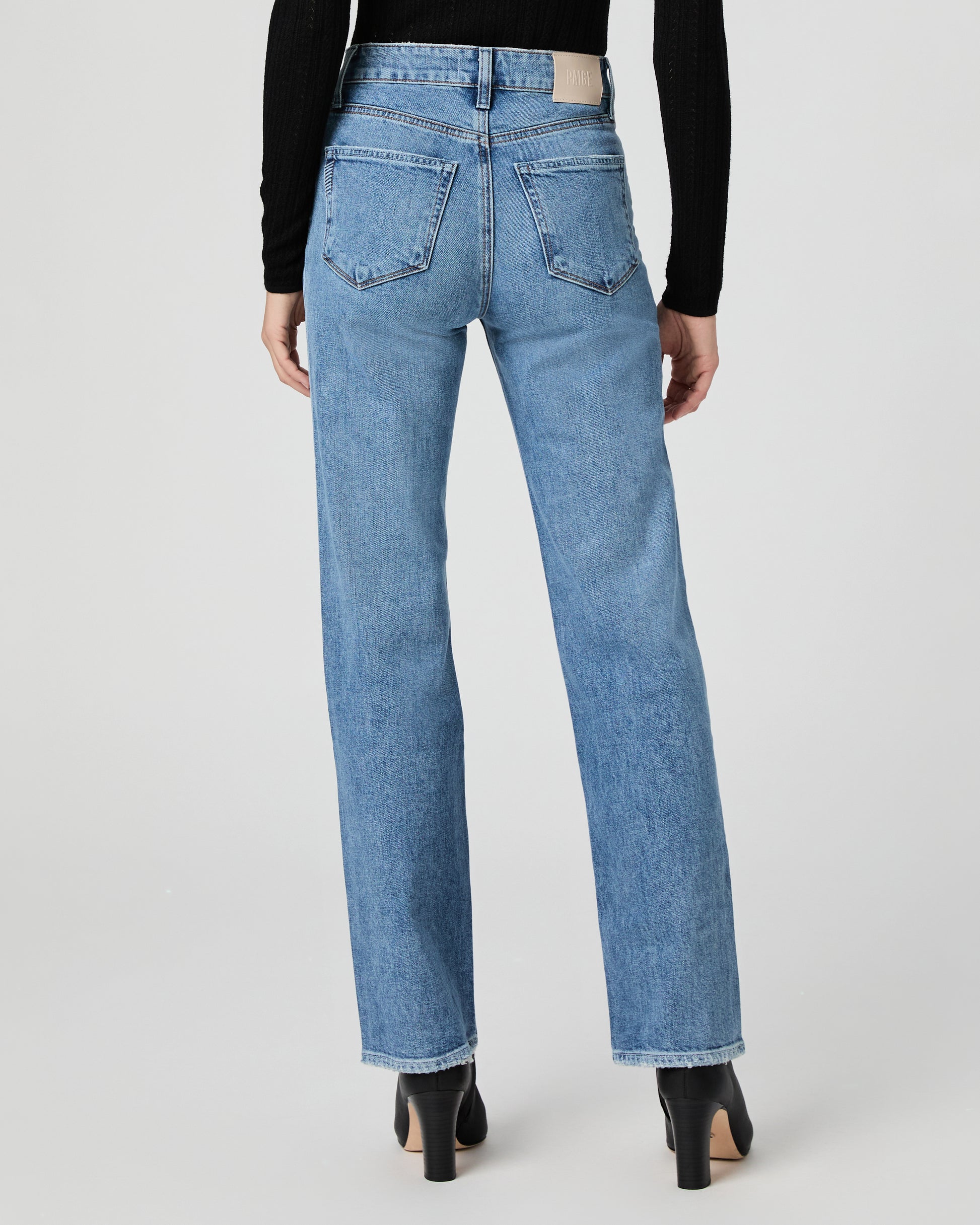Light blue jeans worn by a person on a white background