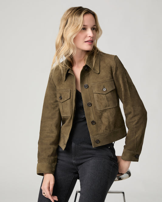 Close-up front view of a woman wearing the buttoned rich olive suede Feyd Jacket, hand near the collar.