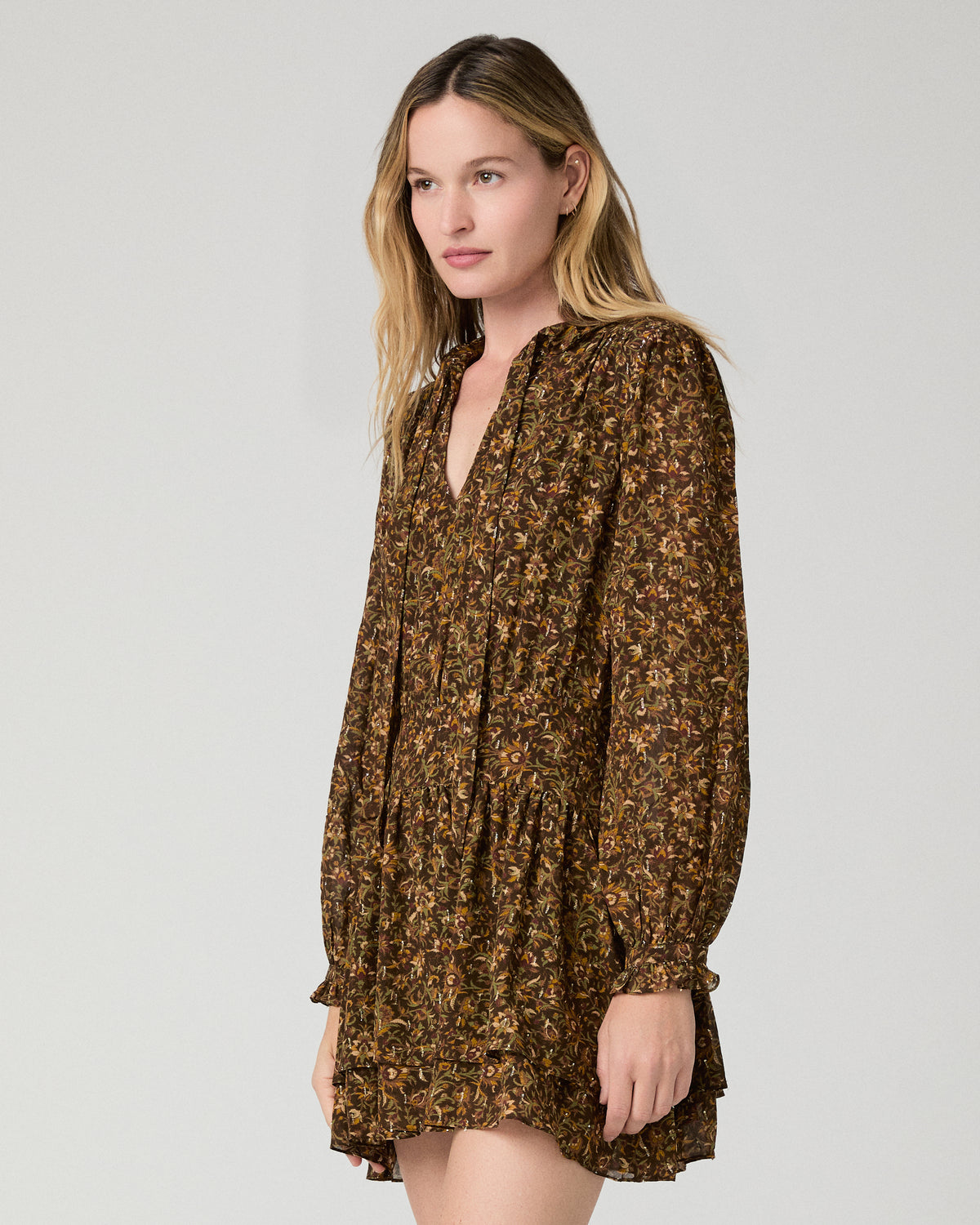 Women wearing flower printed brown dress against a white background