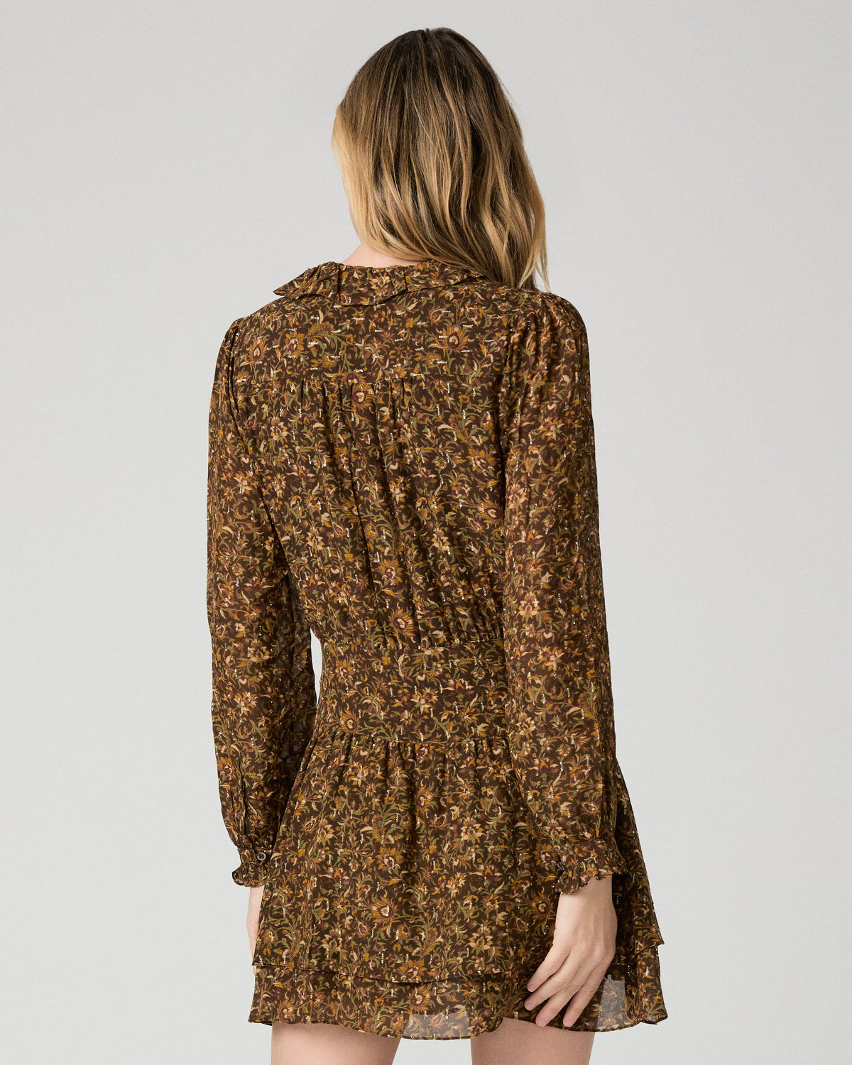 Women wearing flower printed brown dress against a white background