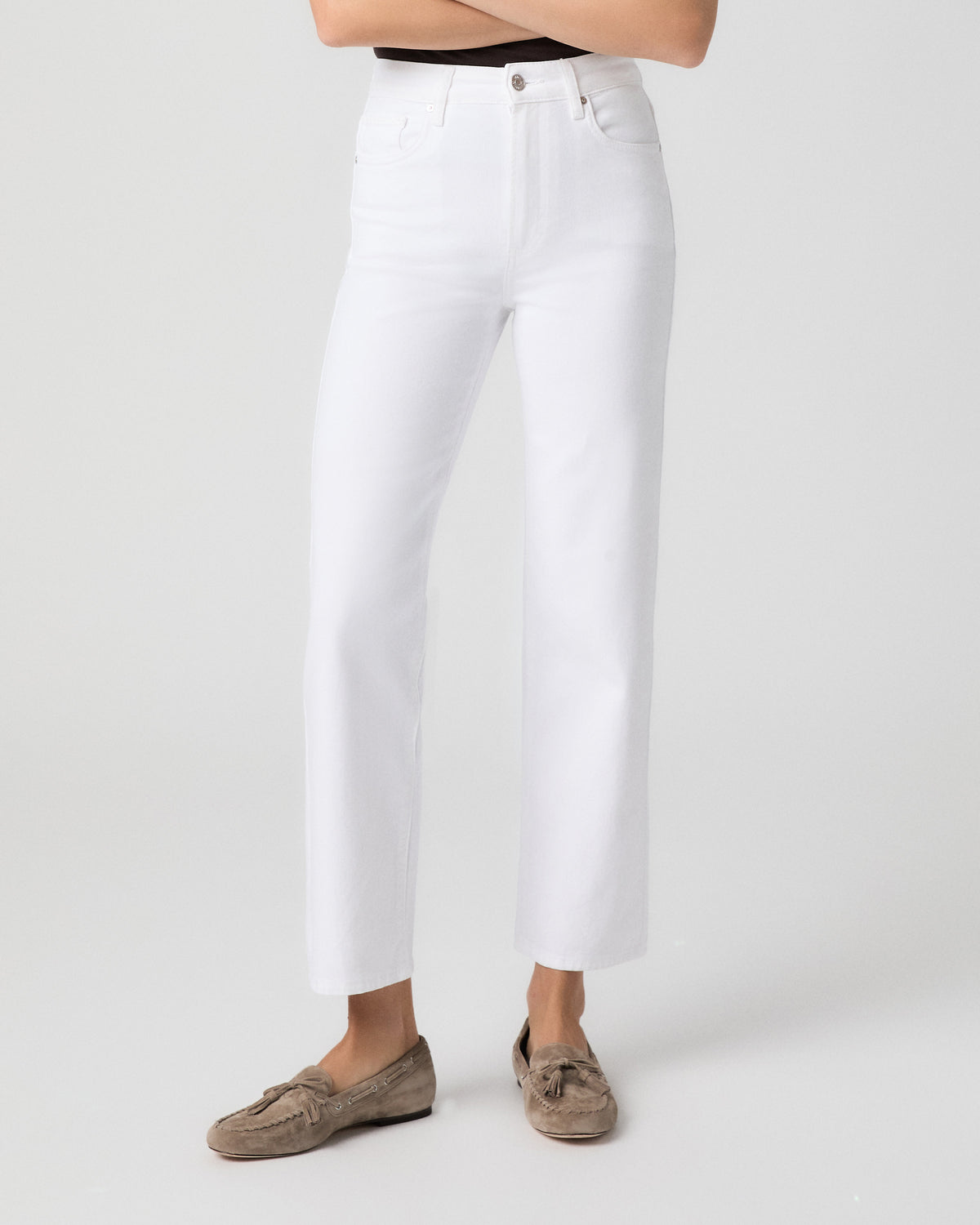 Front view from the waist down of model with arms crossed, wearing Stevie Ankle Straight Jeans in Radiant White with taupe suede loafers
