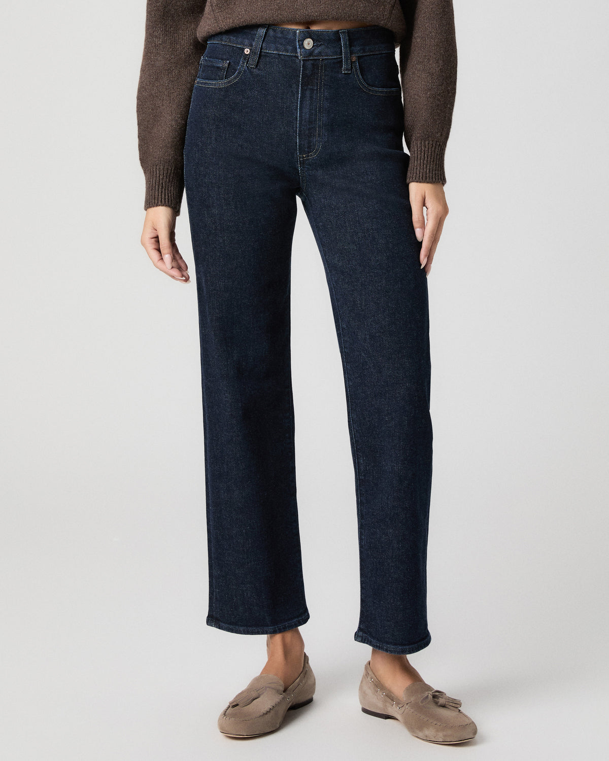 Front view from the waist down of the Stevie Ankle Straight Jean in Moderne dark wash, worn with a brown sweater and taupe suede loafers