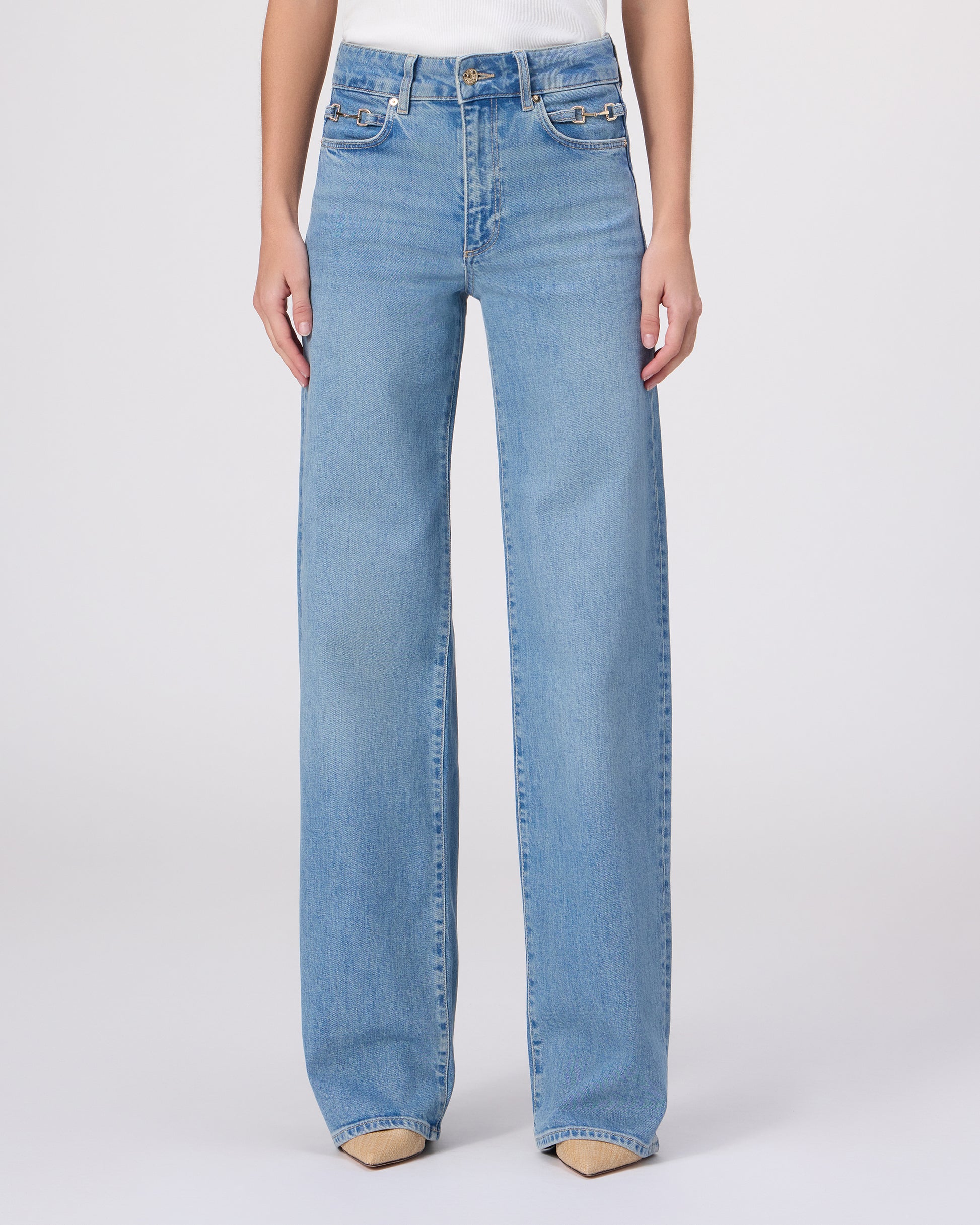 Woman wearing a white blouse and blue jeans on a white background