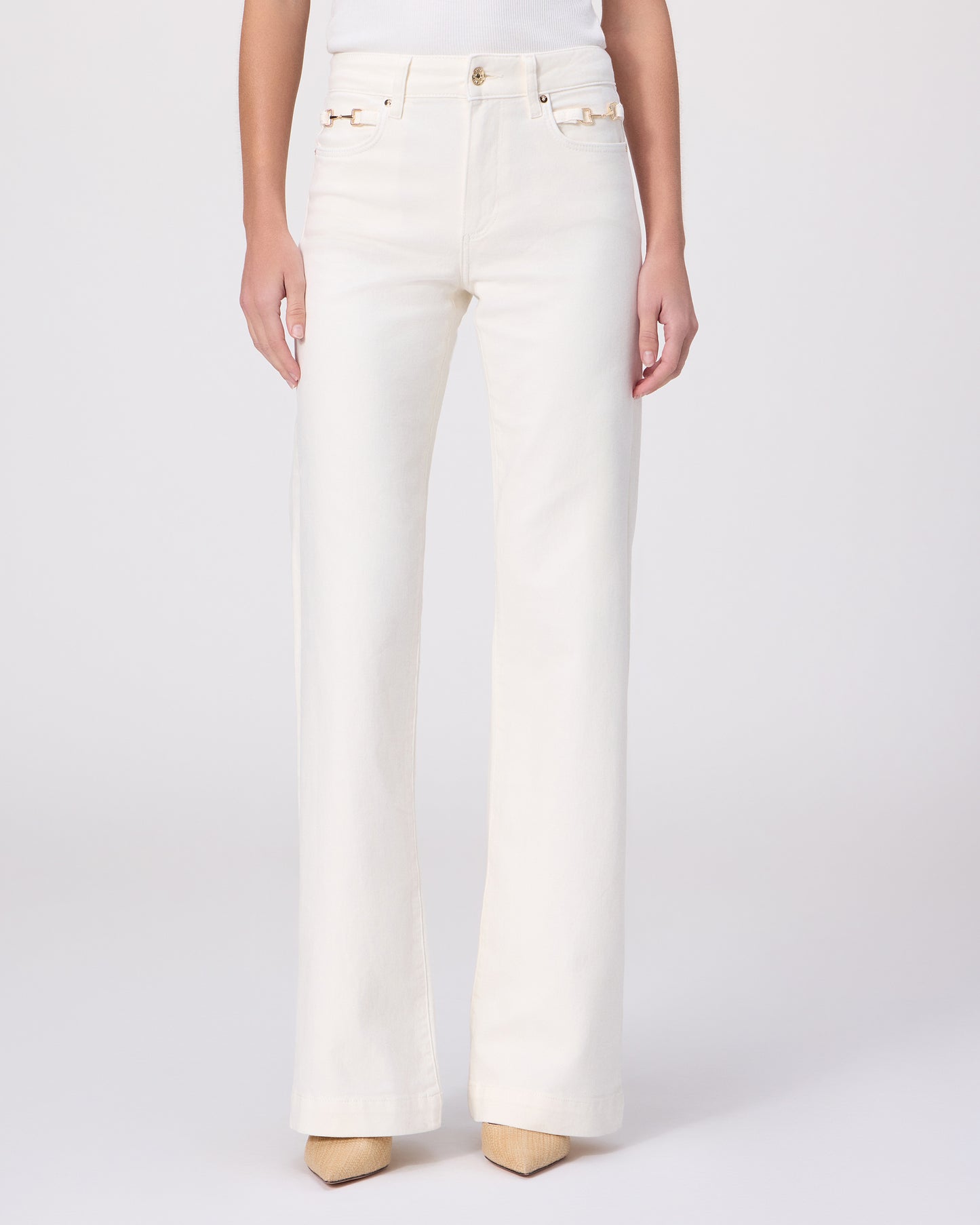 Woman wearing a white tee and white pants on a white background