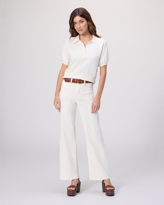 Woman wearing a white outfit with a brown belt on a white background