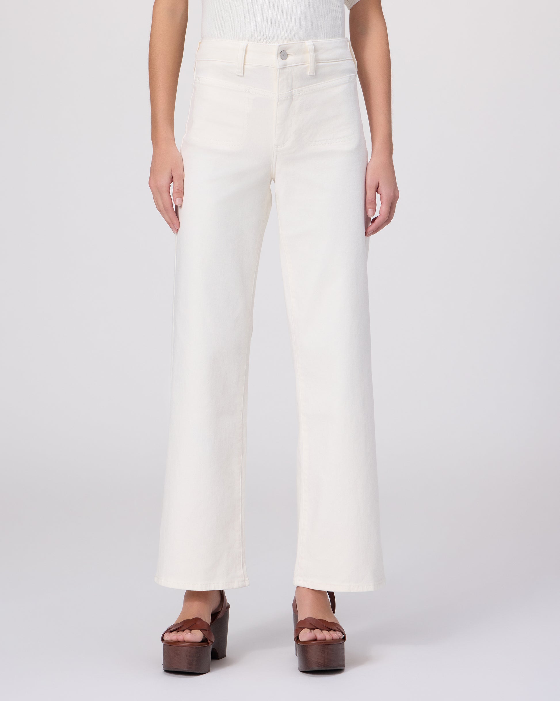 Woman wearing a white outfit with a brown belt on a white background