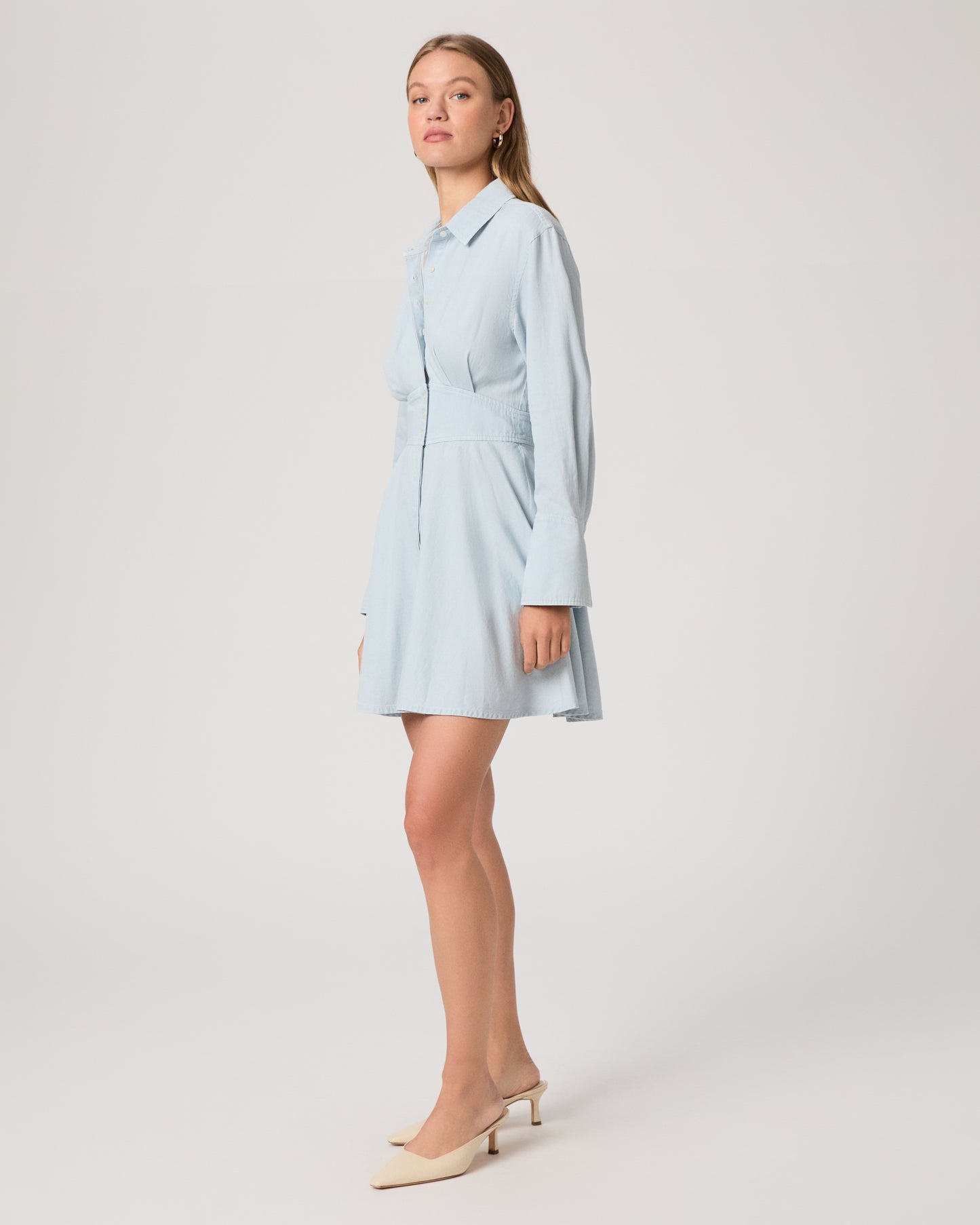 Woman wearing a light blue dress on a white background