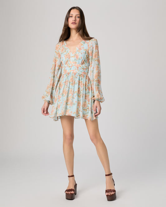 Woman wearing a floral dress on a plain background