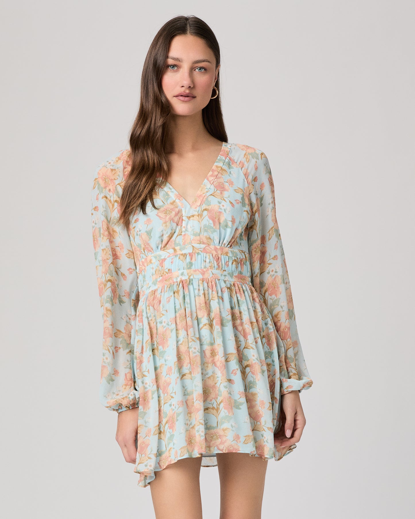 Woman wearing a floral dress on a plain background