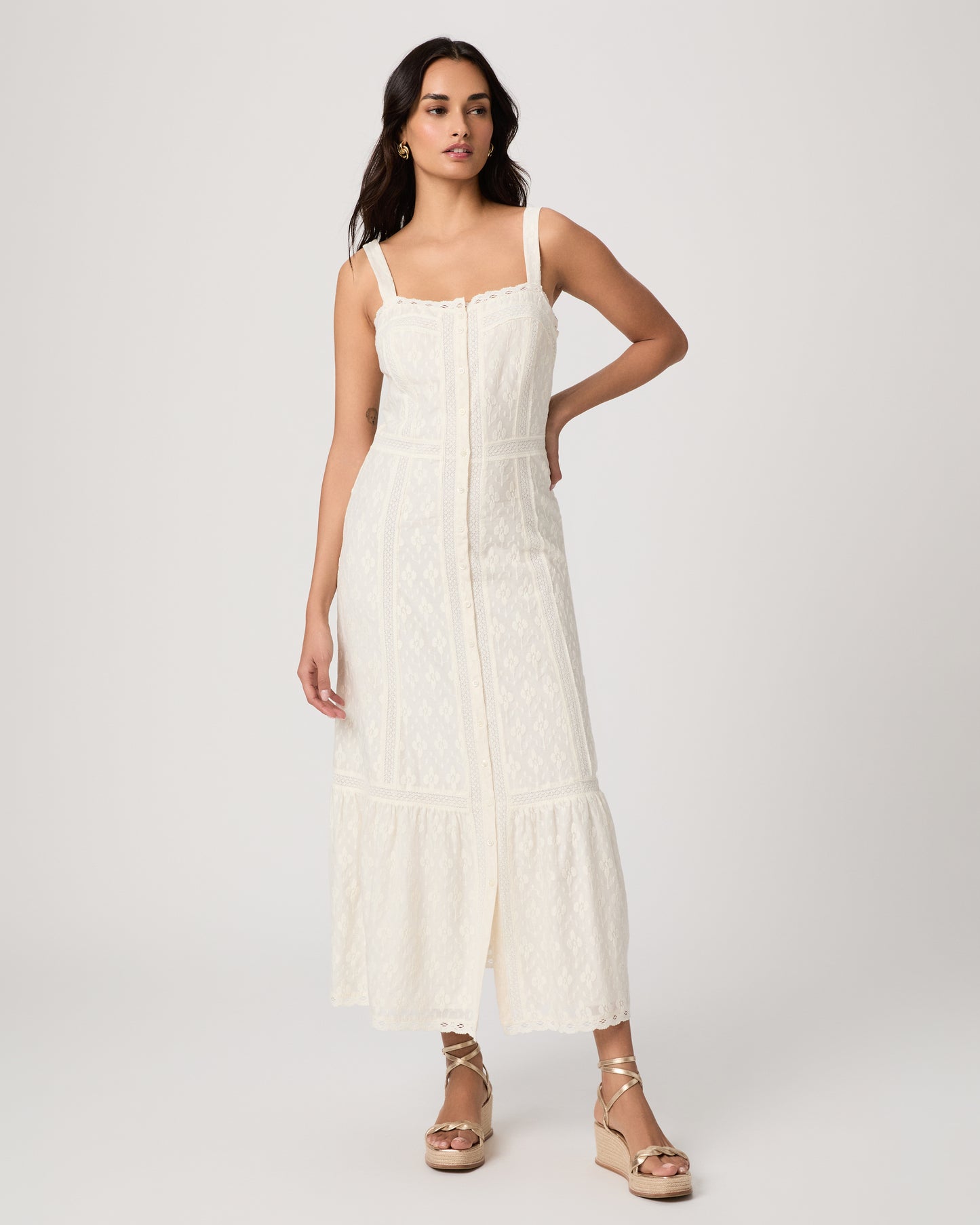 Woman wearing a white dress on a plain background