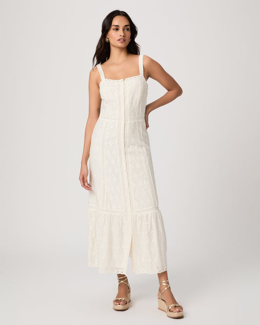 Woman wearing a white dress on a plain background