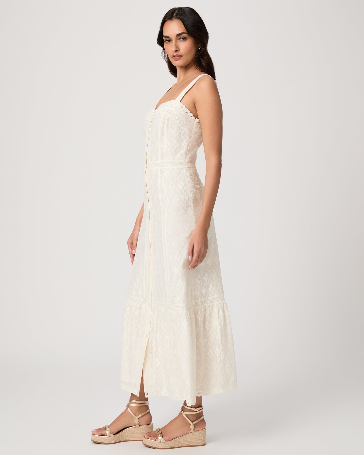 Woman wearing a white dress on a plain background