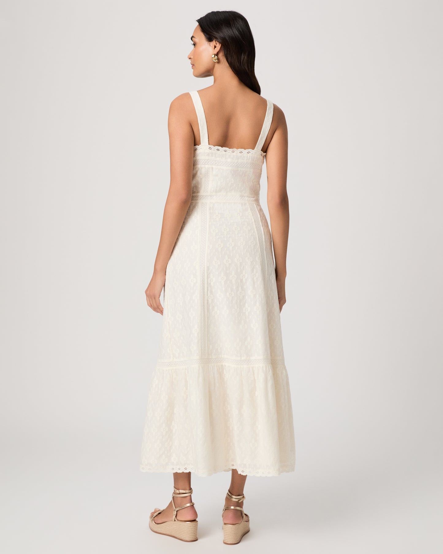 Woman wearing a white dress on a plain background