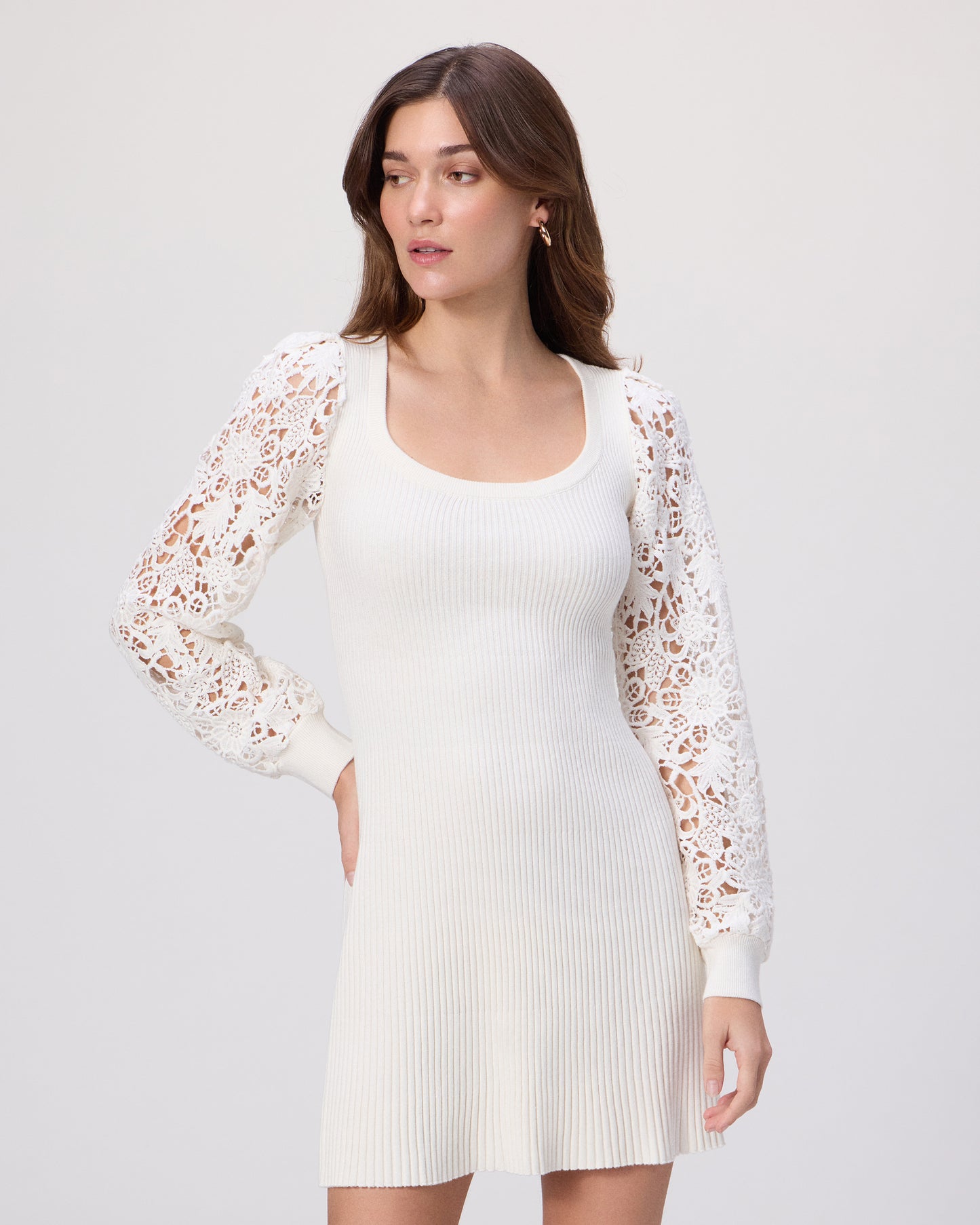 Woman wearing a white dress with a lace sleeves on a white background