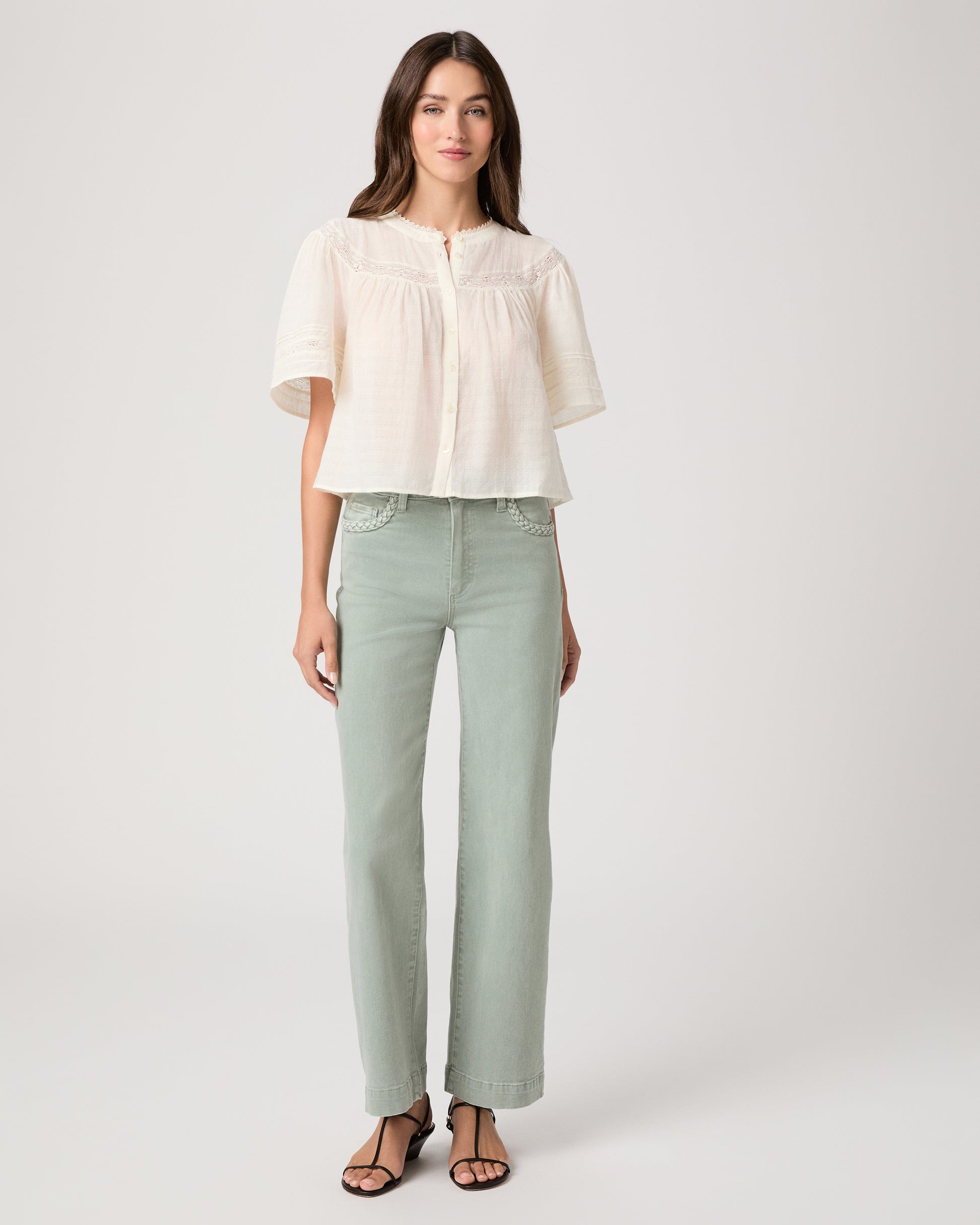 Pasadena Blouse - Ivory Model wearing a white top paired with light green pants with brown sandals