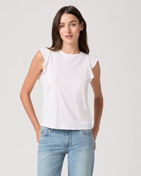 Model wearing a white tee paired with a light wash denim
