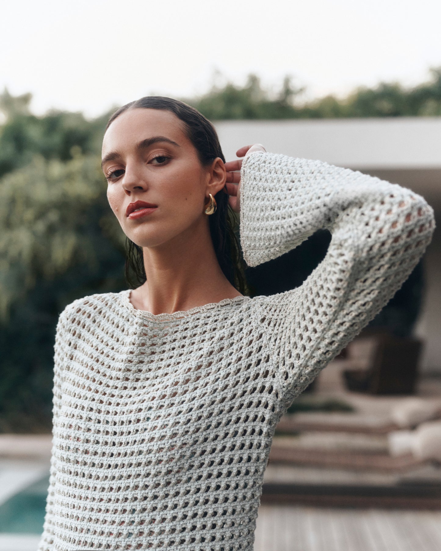 Woman wearing a light green crochet dress outdoors
