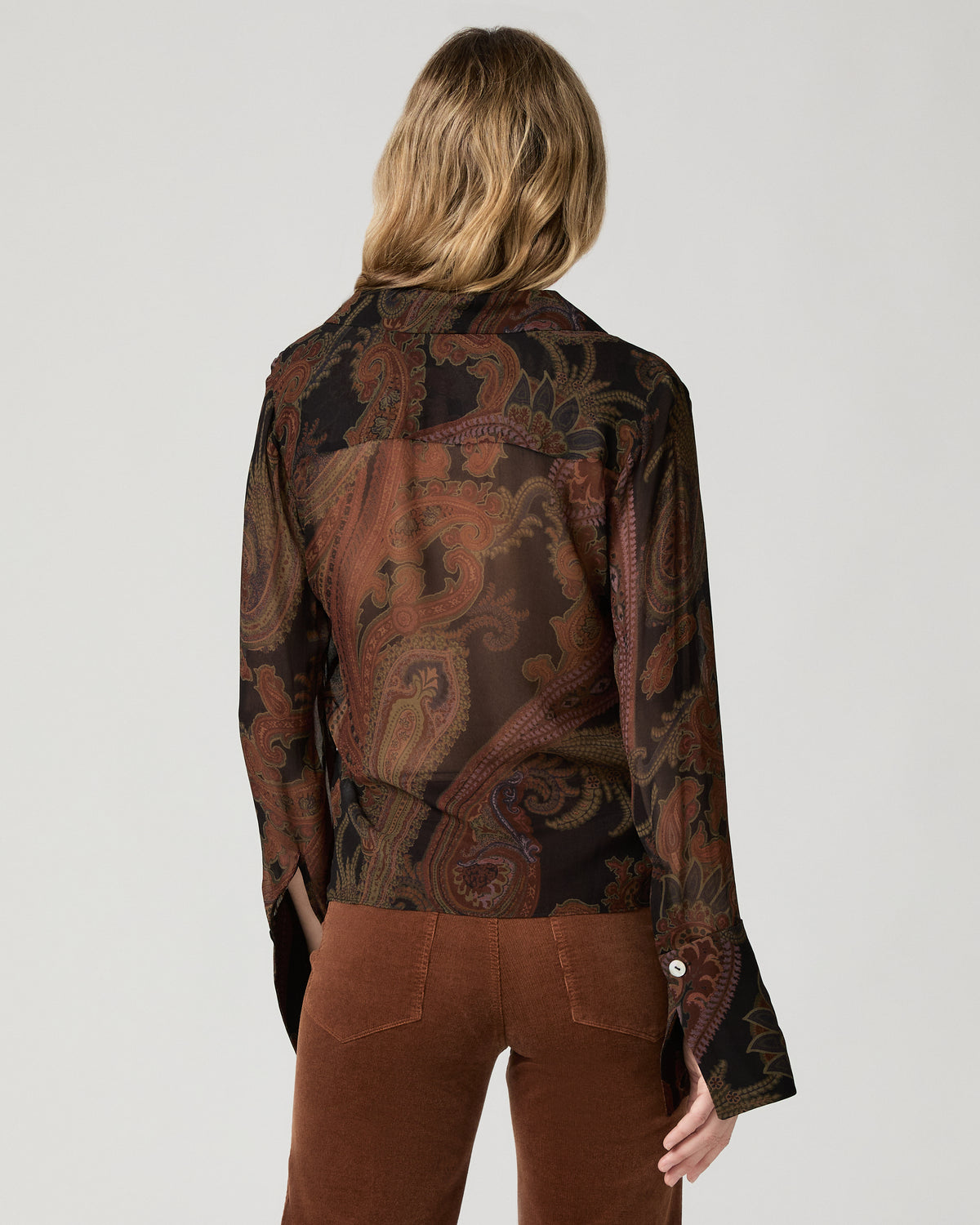 Close-up back view of a woman wearing the black and brown paisley-print Rosalinda Blouse.