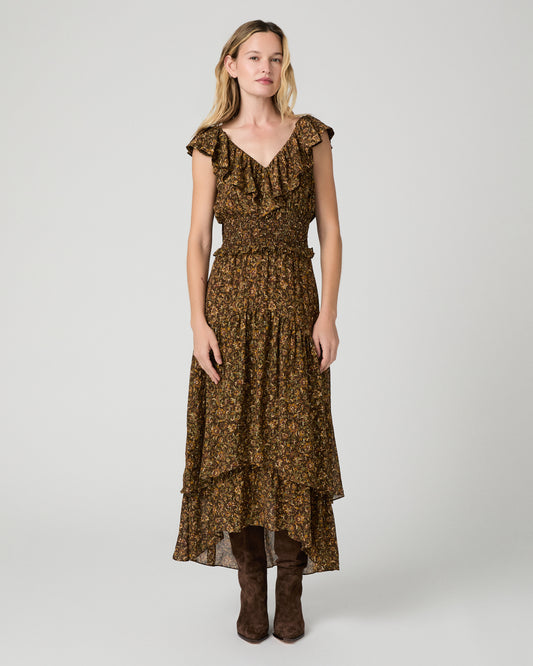 Women wearing a flower printed brown dress and paired with brown boots against a white background