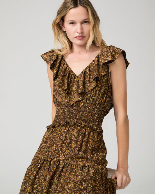 Women wearing a flower printed brown dress and paired with brown boots against a white background