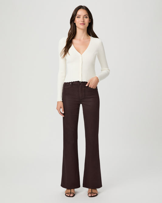 A woman modeling a cream long-sleeve knit cardigan with a V-neck and button front, paired with dark brown wide-leg pants, against a light gray studio background.