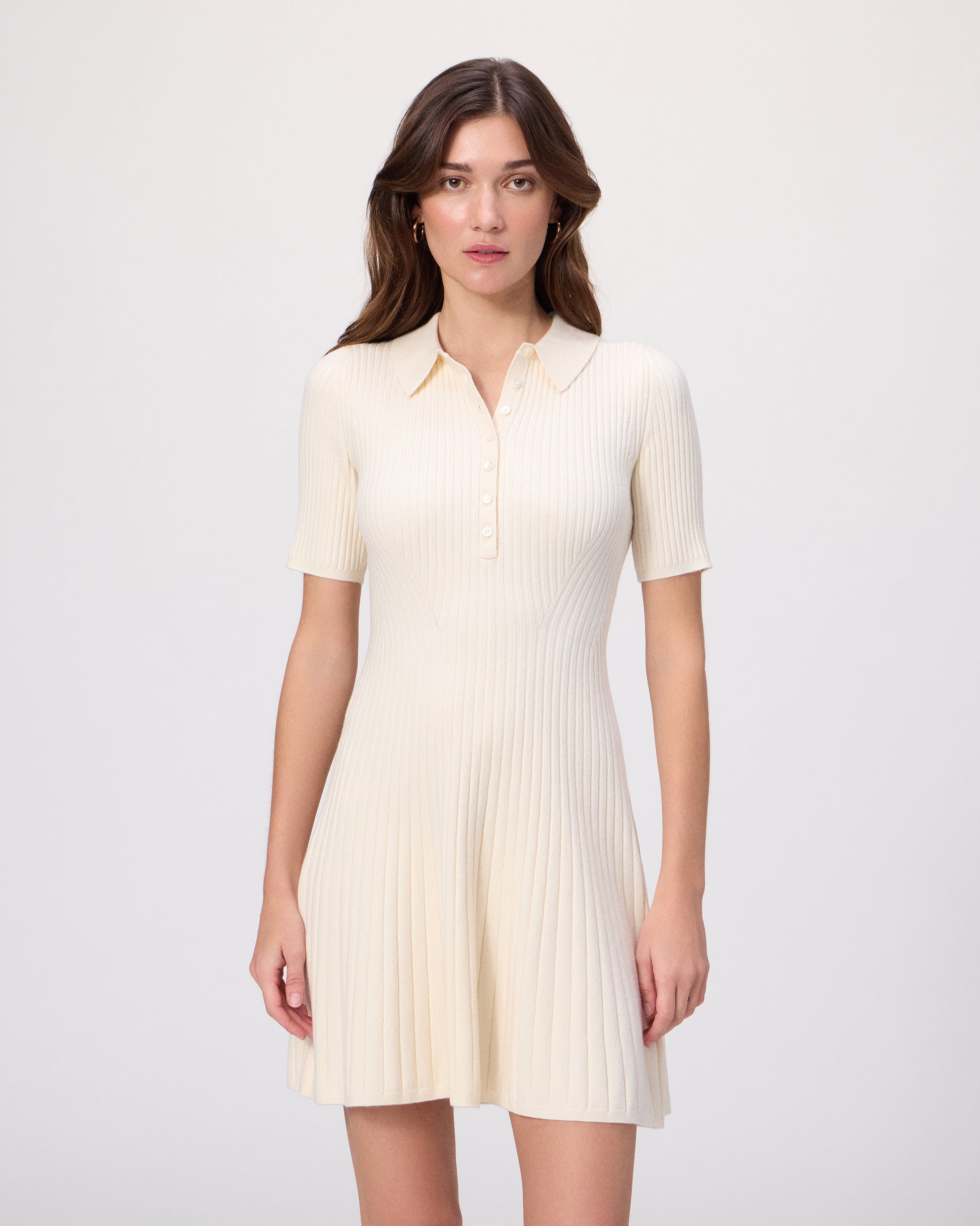 Model wearing a white dress and brown loafers