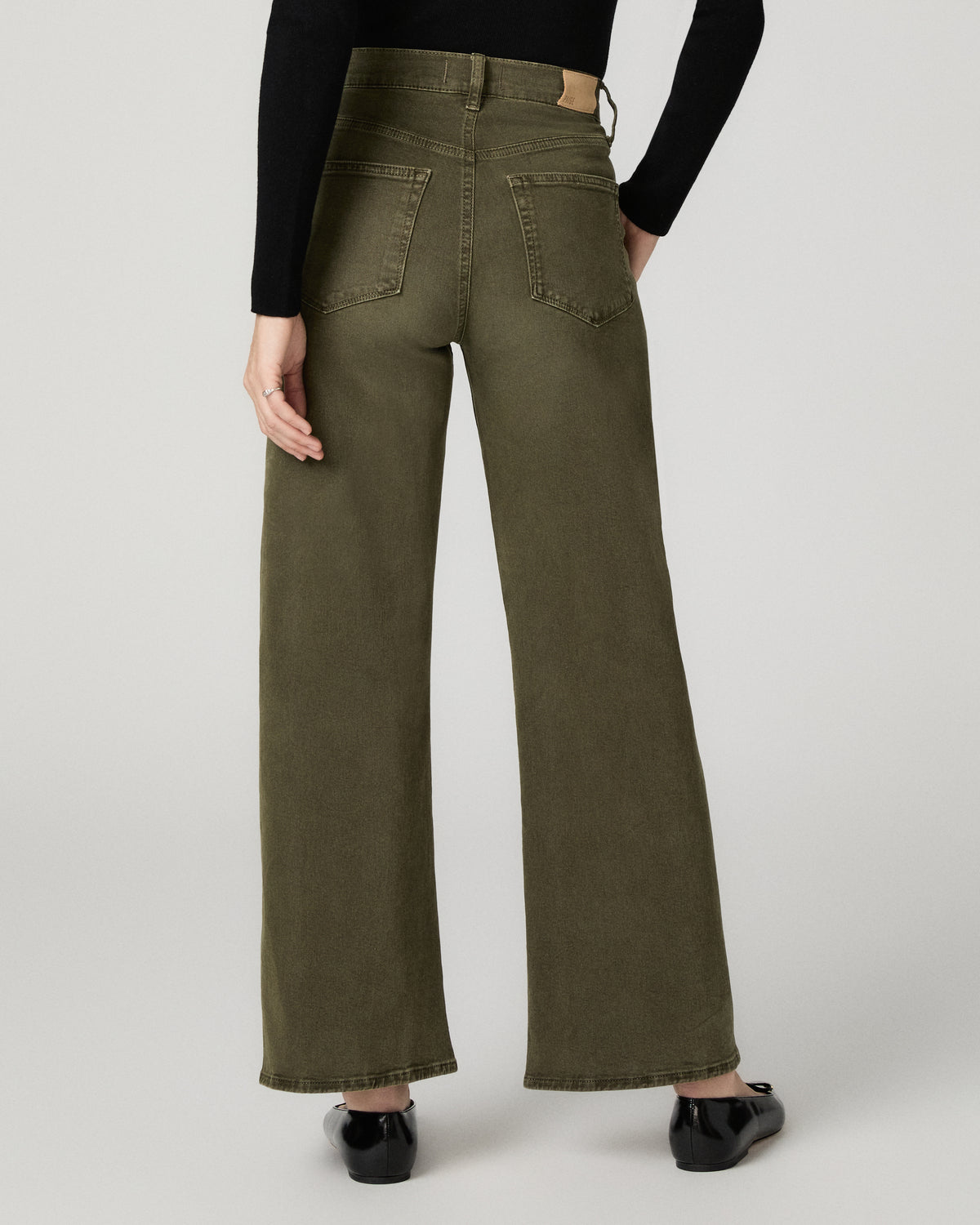 Close-up back view of the olive green Arellia Skimmer Barrel Leg Jean, showing the back pocket and barrel-leg silhouette.