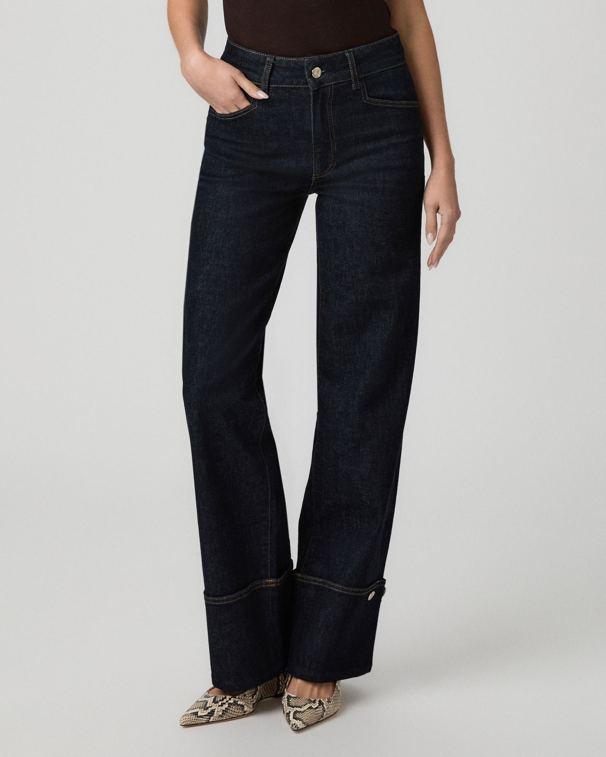 Front close-up of the Sasha Wide Leg Jean in dark indigo wash with turned-up cuffs and hardware details
