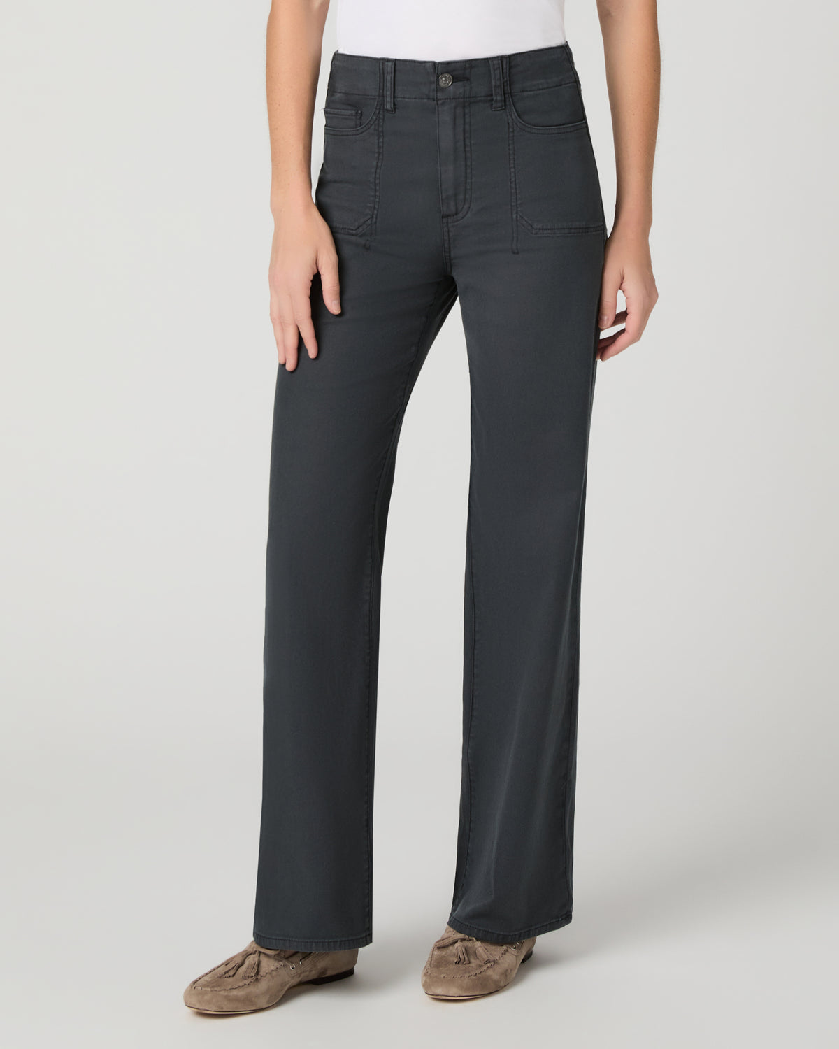 Women wearing a white tee and grey pants paired with brown flats against a white background