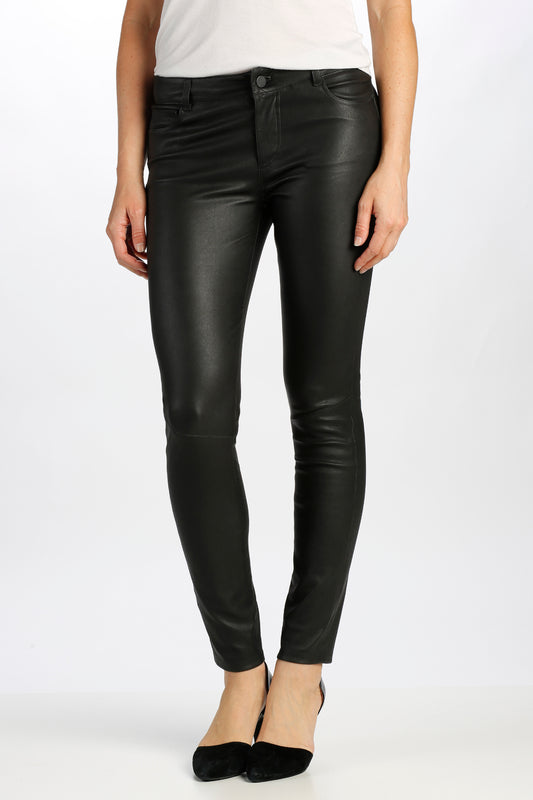 Person wearing black leather pants on a white background