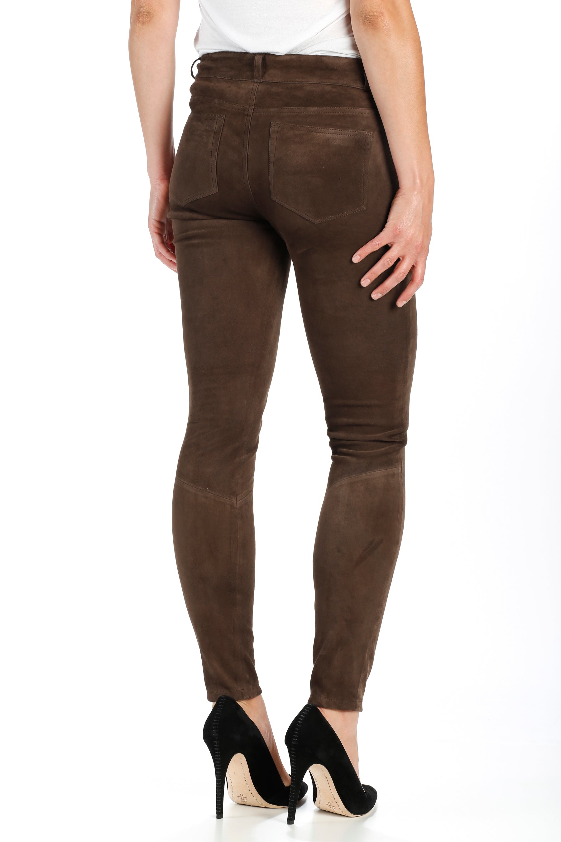 Brown pants worn by a person on a white background