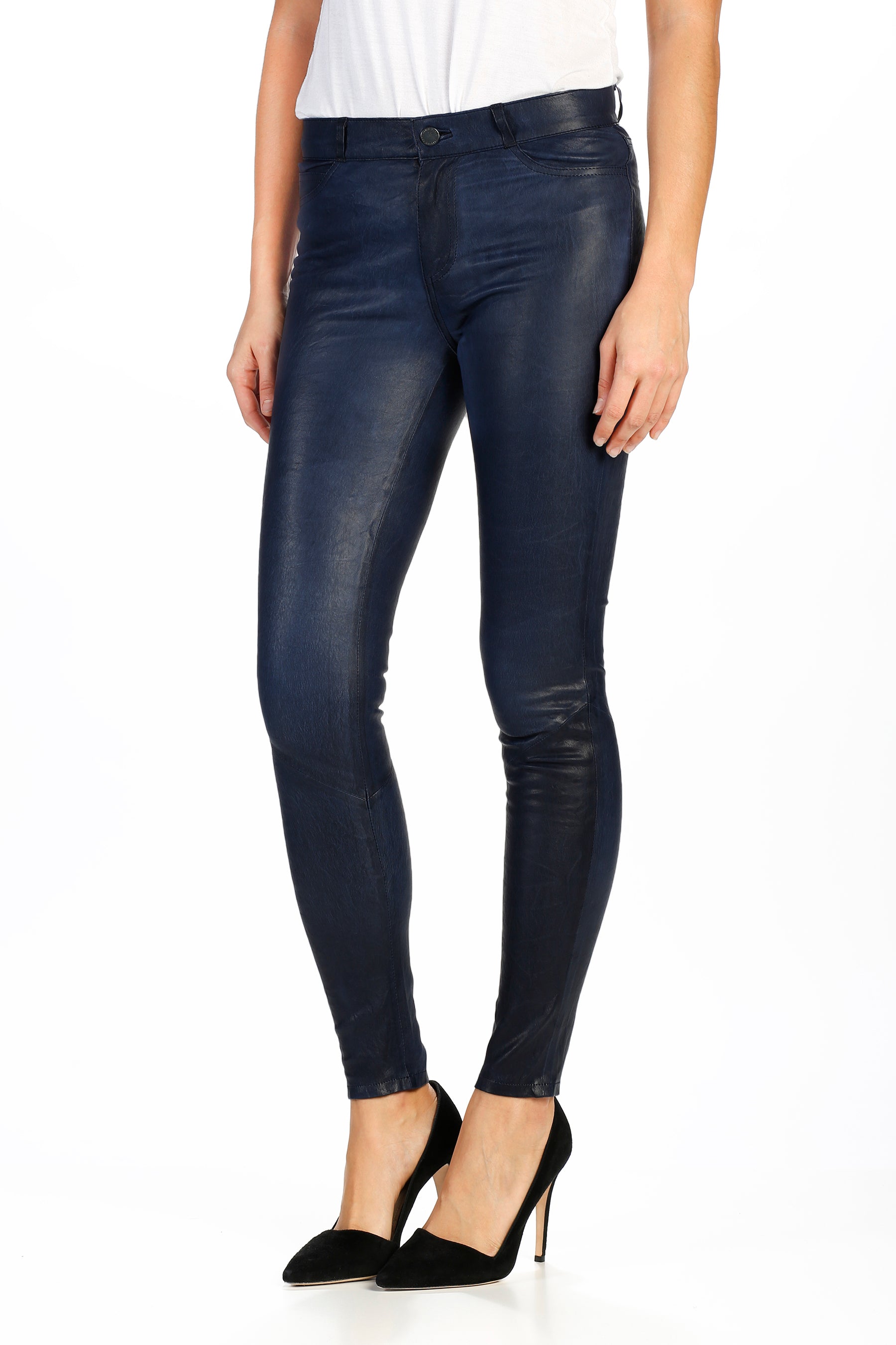 Dark blue leather pants worn by a person on a white background