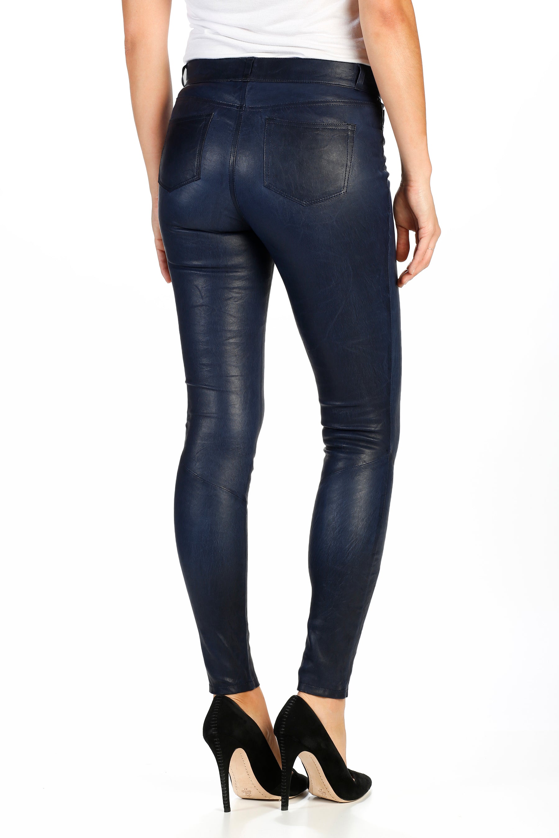 Navy blue leather leggings worn by a person on a white background