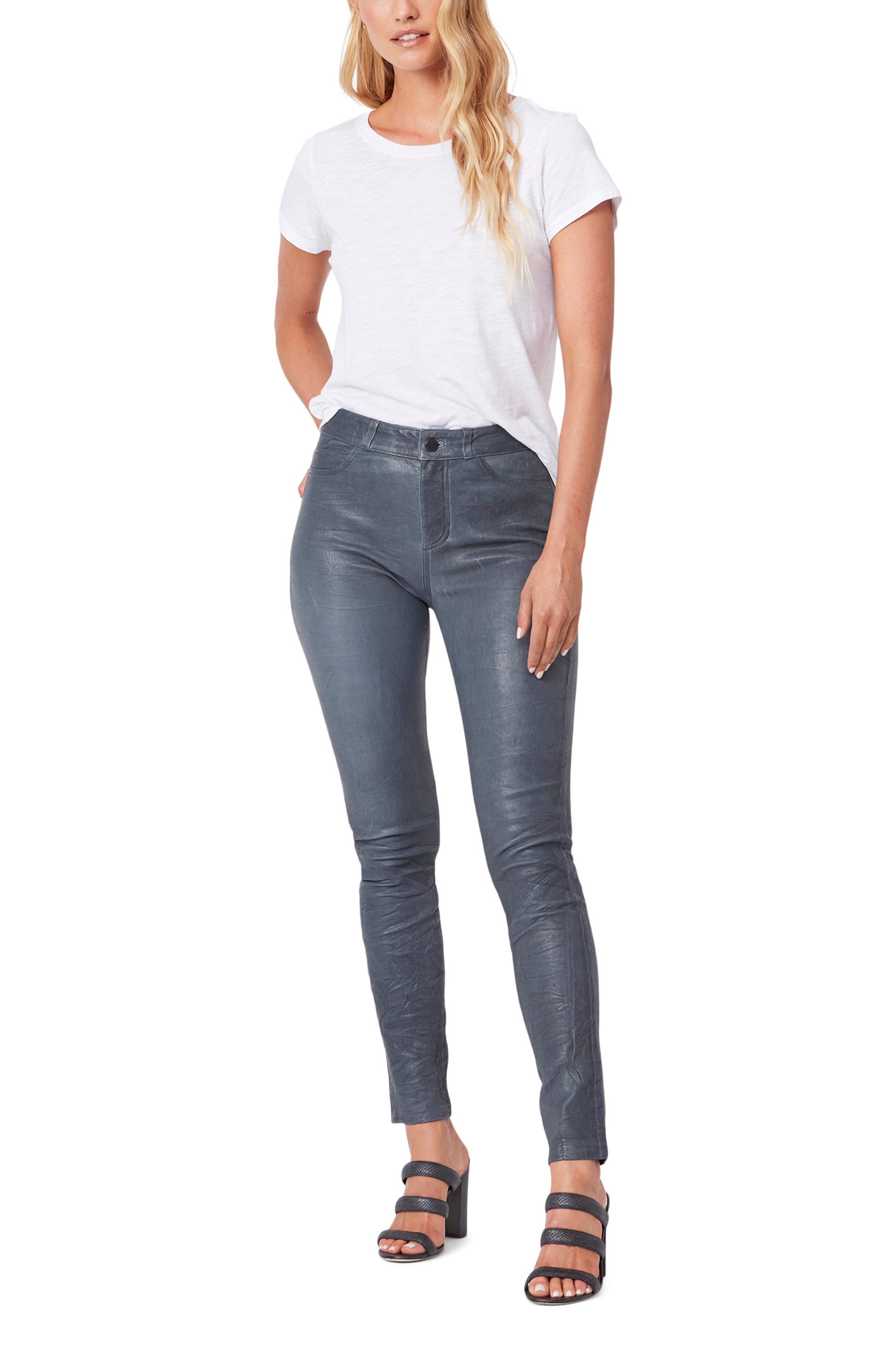 Woman wearing gray high-waisted jeans and a white t-shirt on a white background