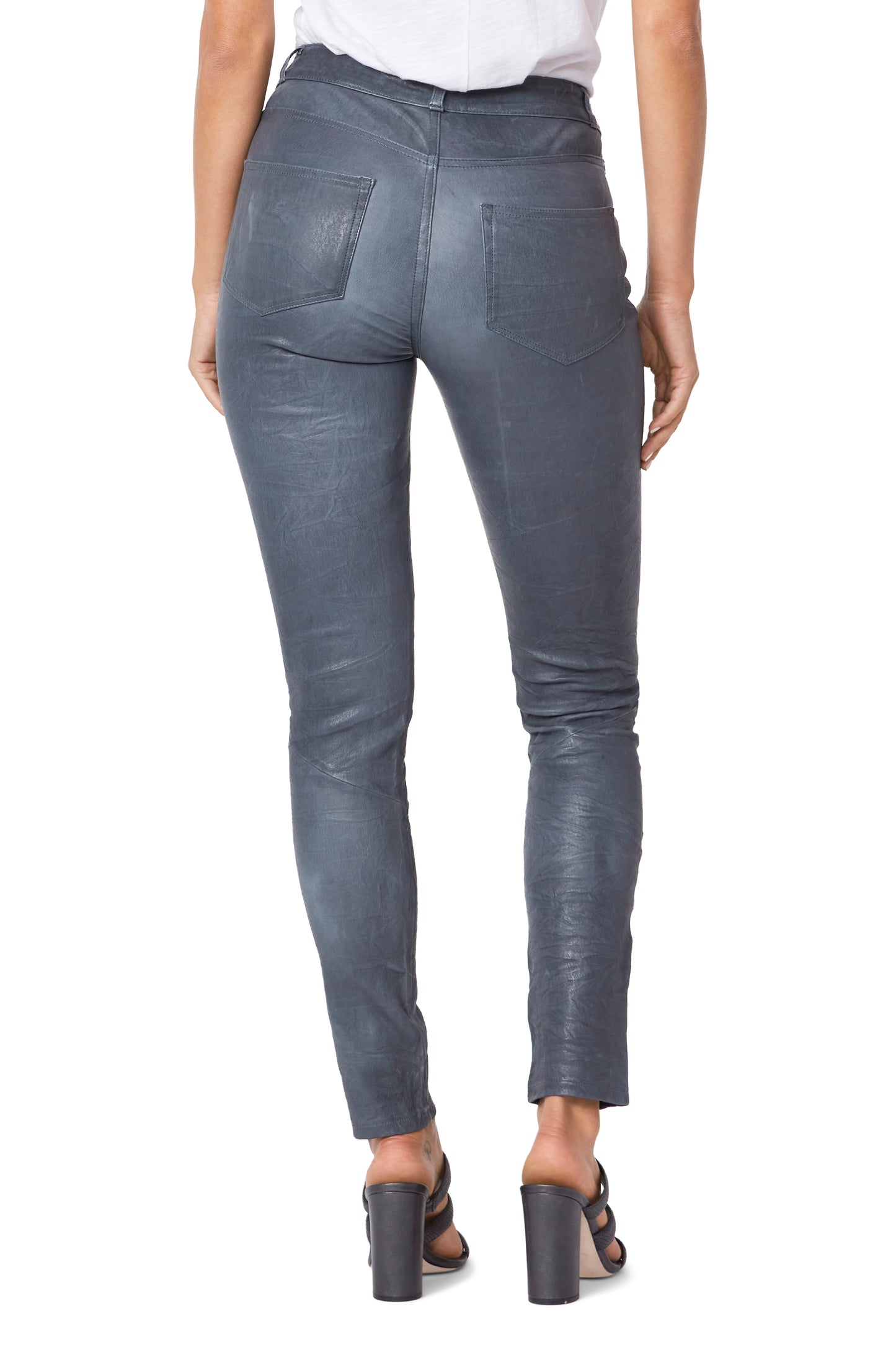Gray leather pants worn by a person on a white background
