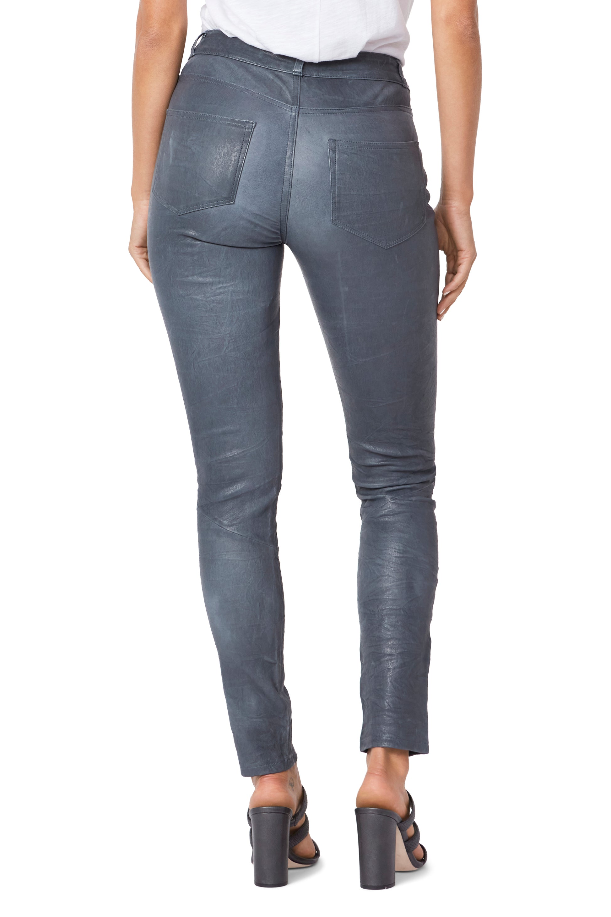 Gray leather pants worn by a person on a white background