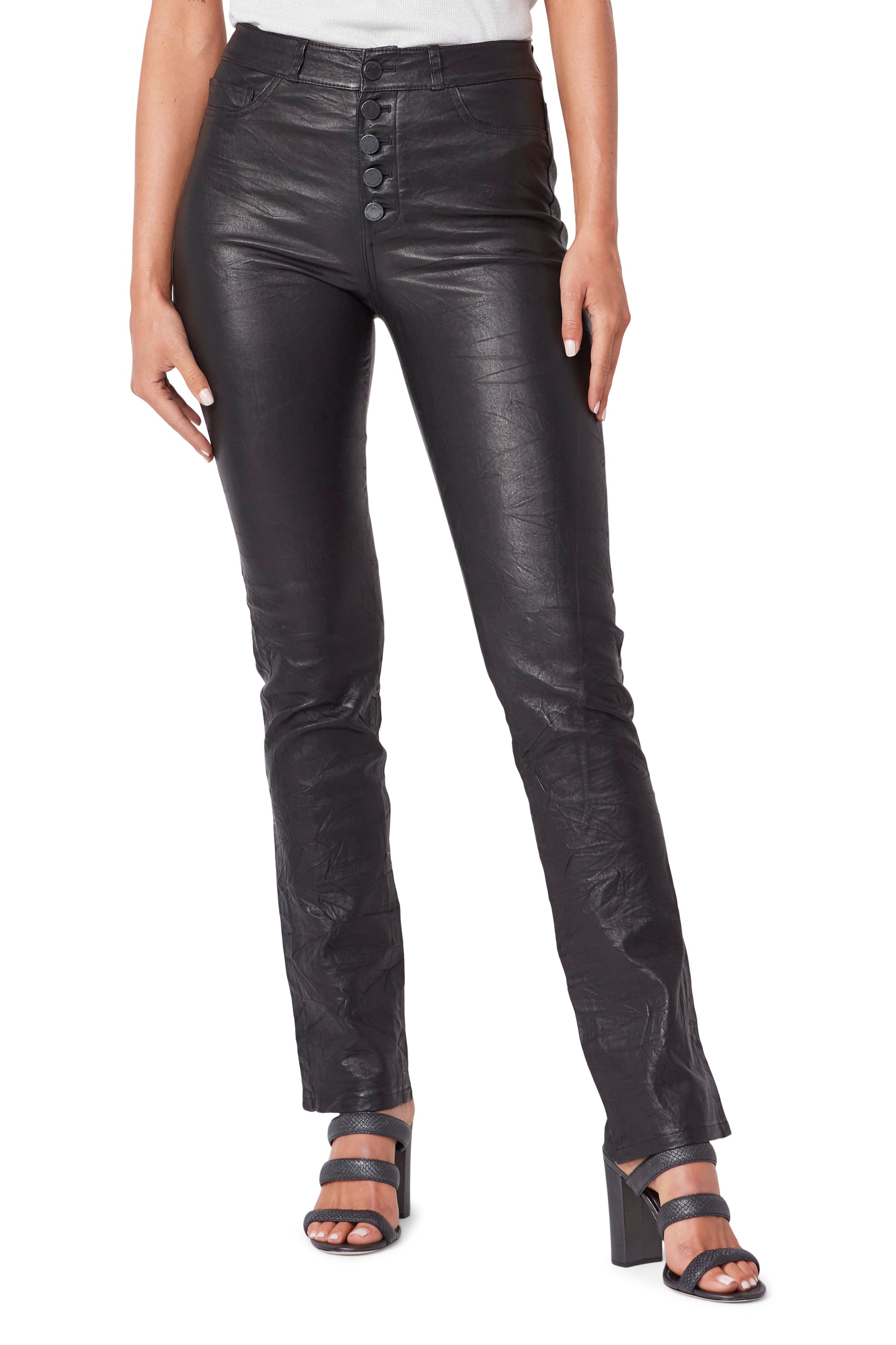Black leather pants worn by a person on a white background