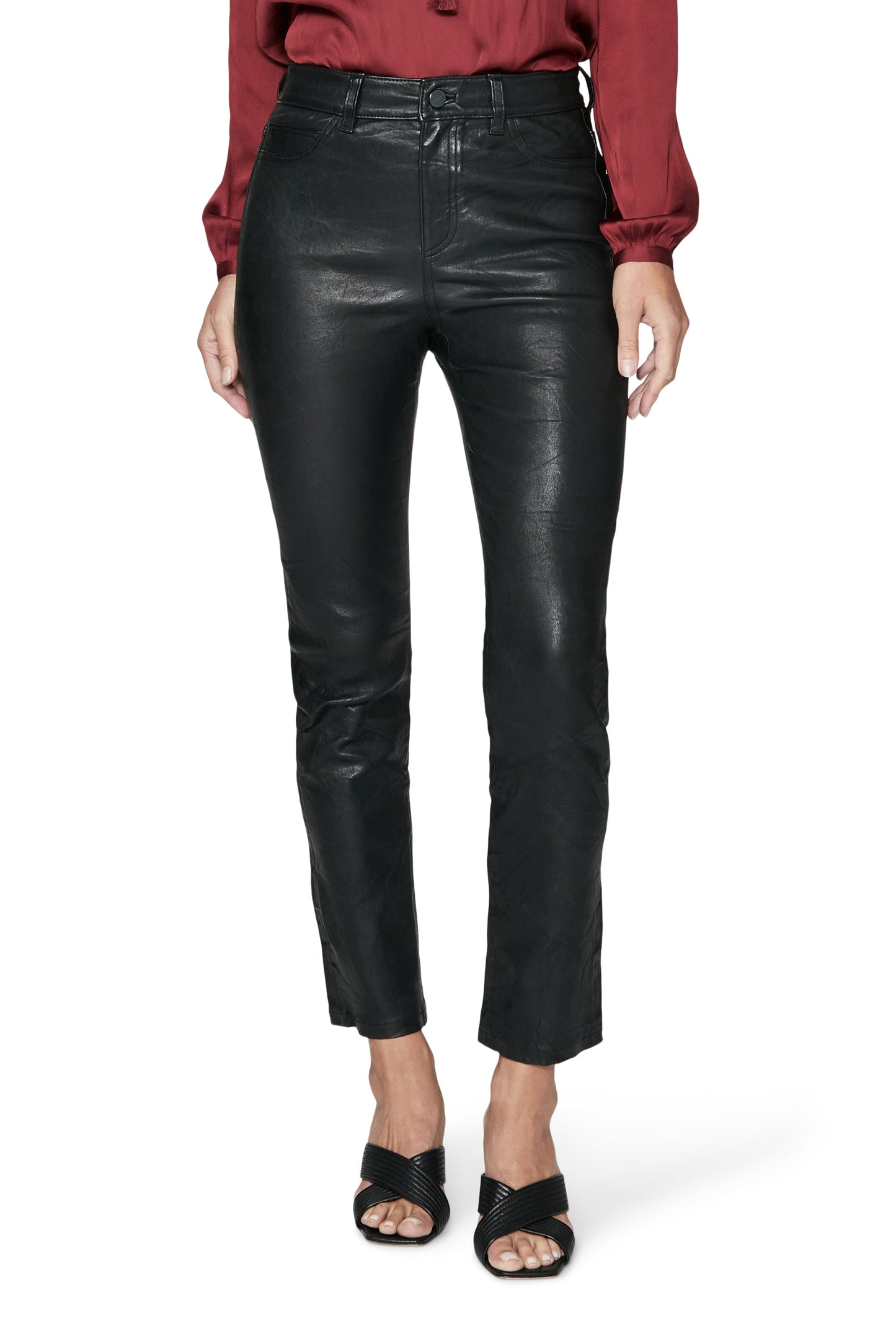 Person wearing black leather pants on a white background