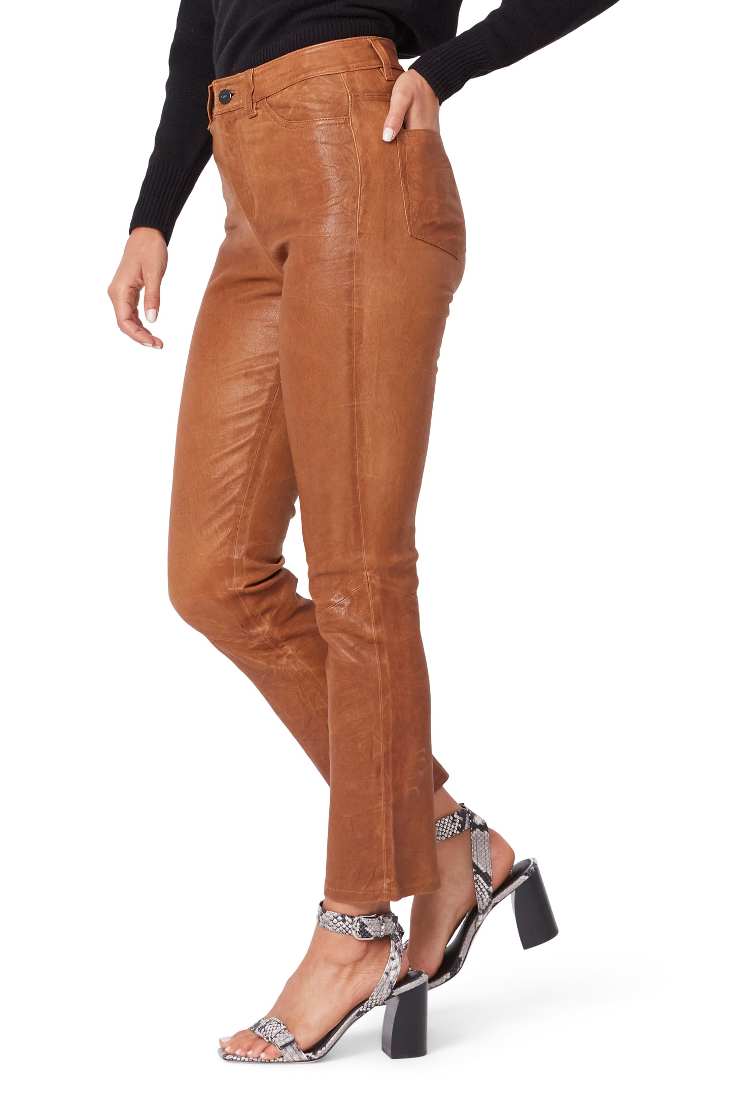 Brown leather pants worn by a person on a white background