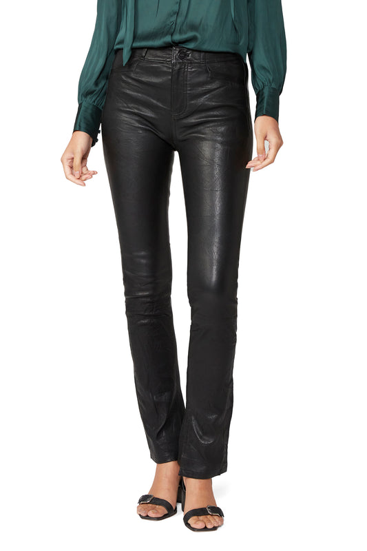 Person wearing black leather pants on a white background