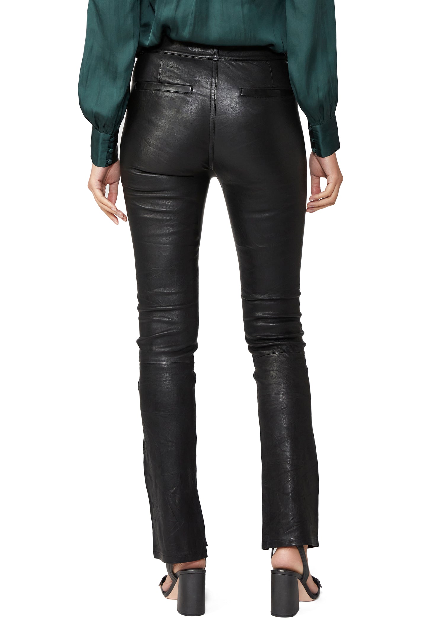 Black leather pants worn by a person on a white background